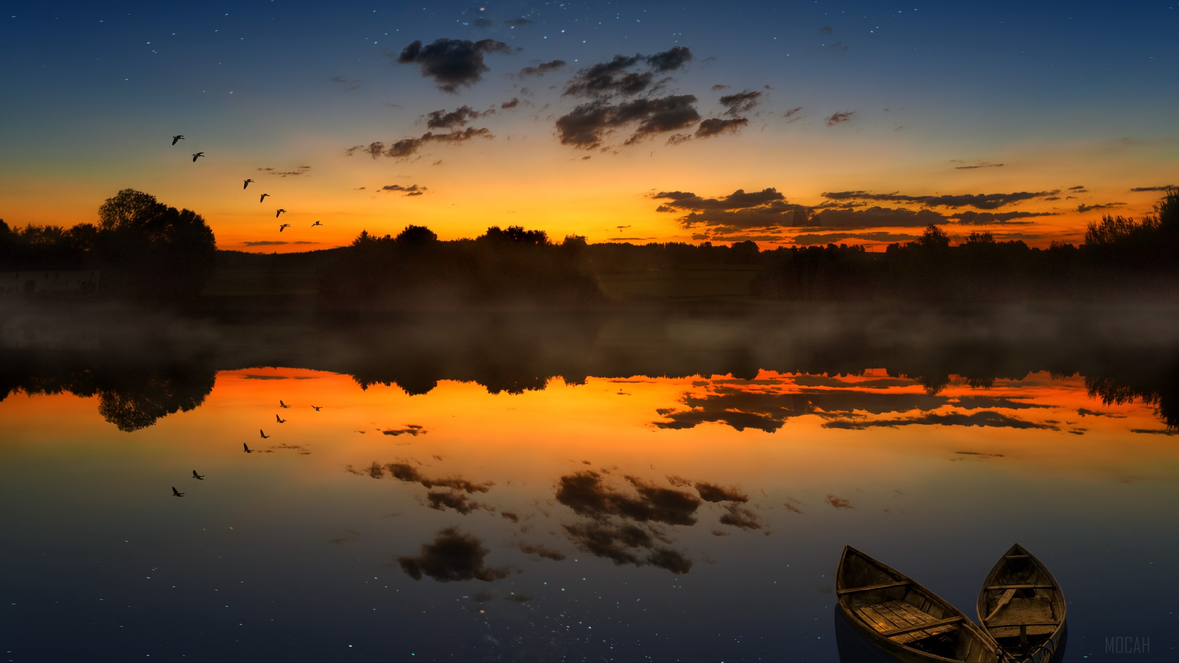 Boats on a lake at sunset with birds flying HD Wallpaper