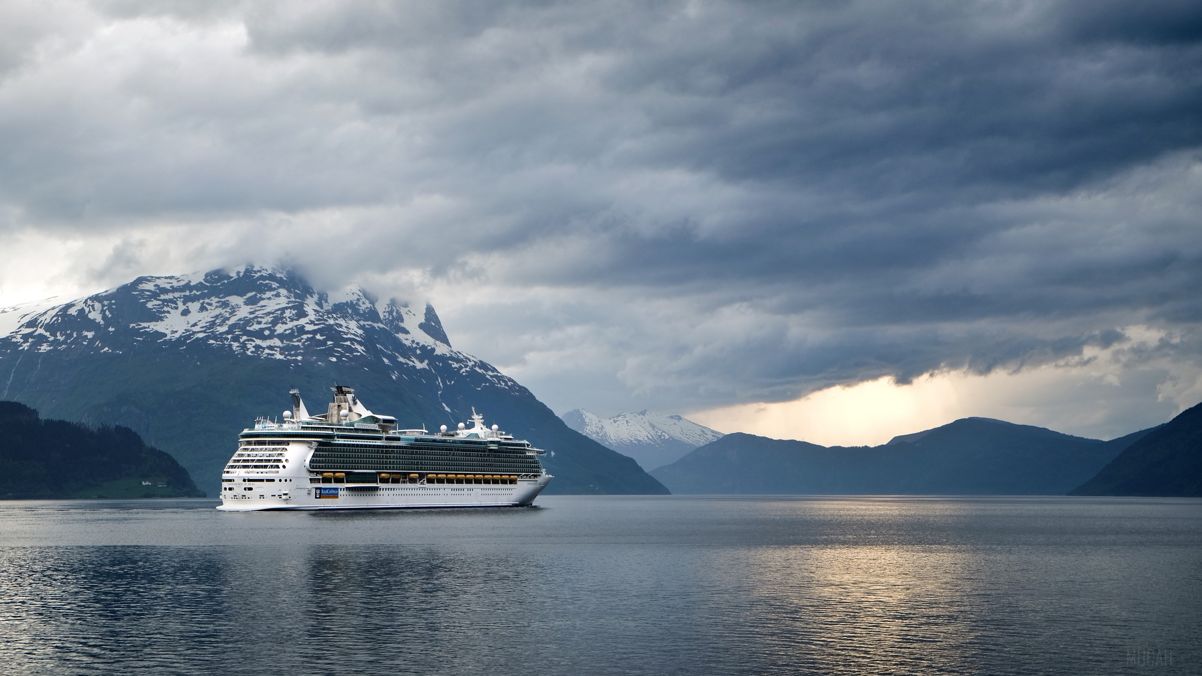Cruise ship sailing in a fjord with mountains HD Wallpaper