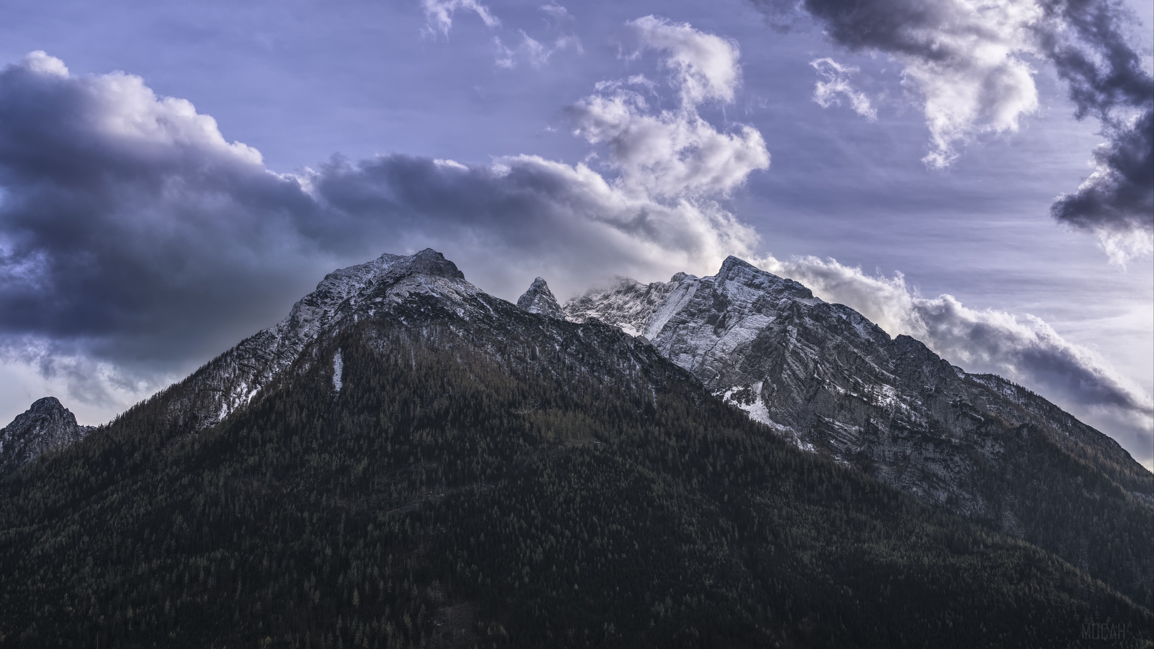 Snow-capped mountains under dramatic clouds 4K HD Wallpaper