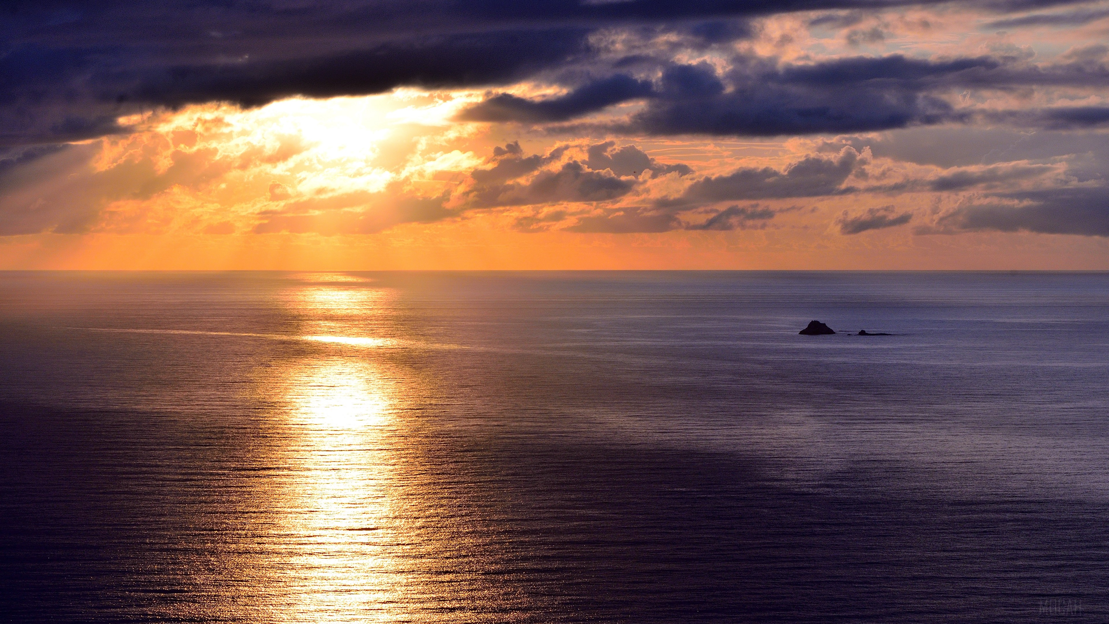 Sunset over the sea with clouds and sunlight reflection HD Wallpaper