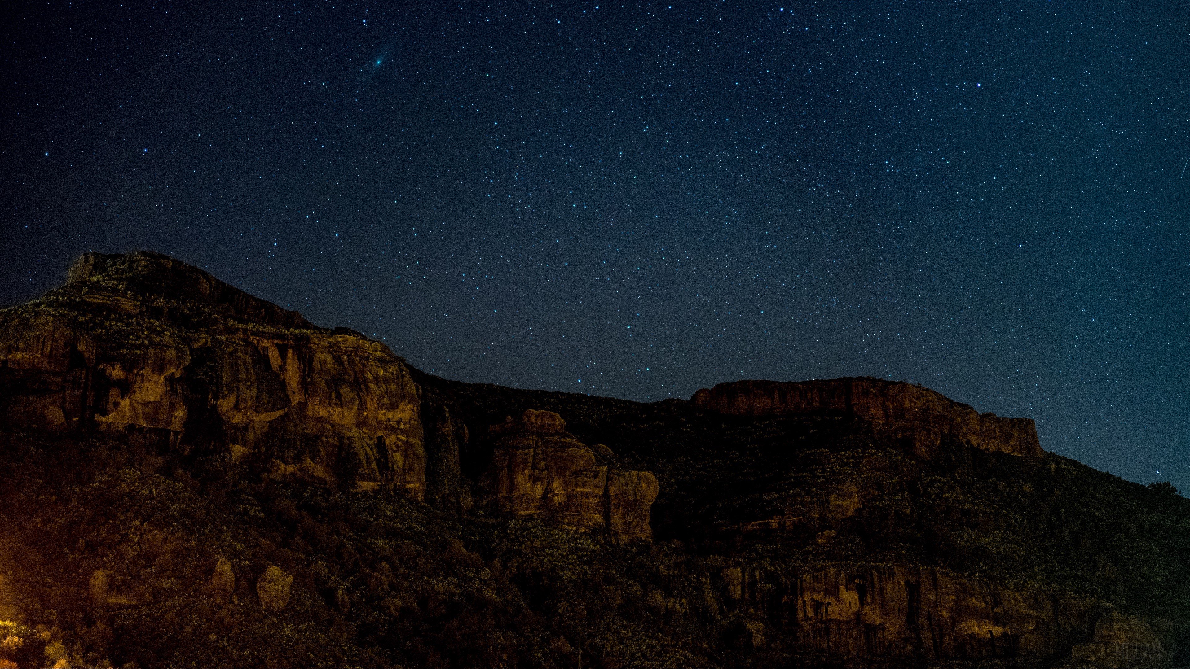 Starry sky over rocky mountains at night HD Wallpaper