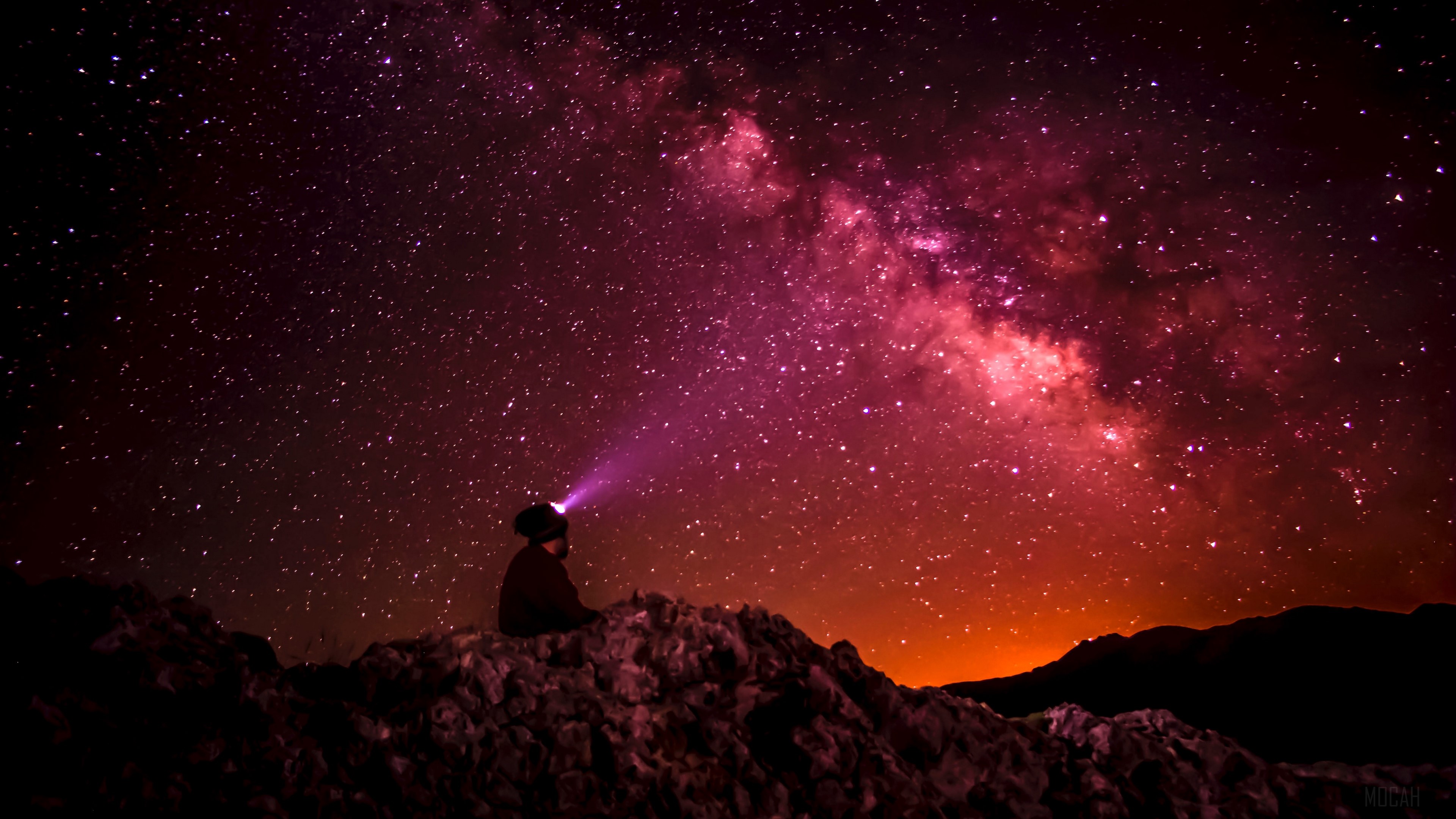 Man with headlamp looking at starry sky HD Wallpaper