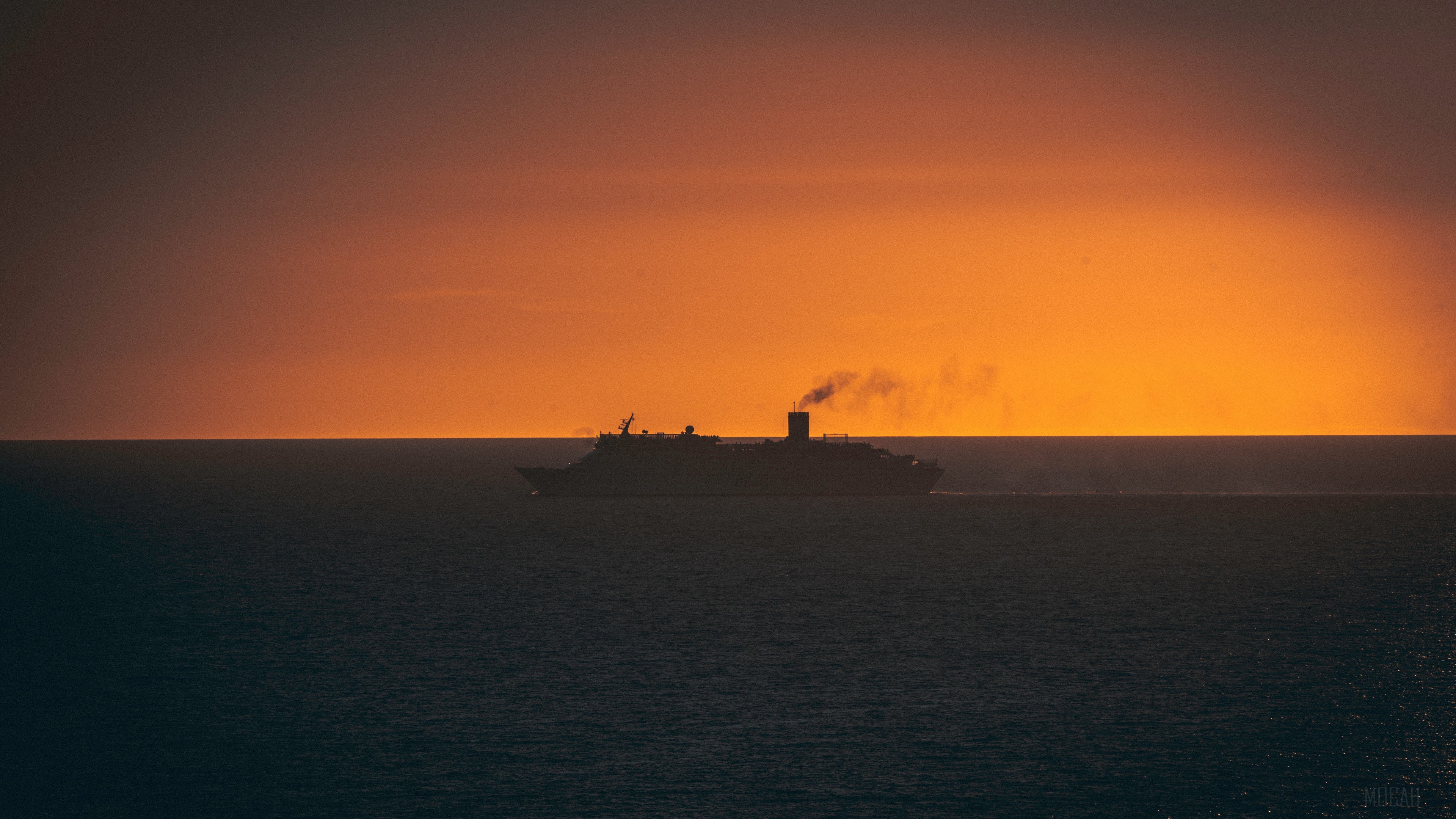 Ship sailing on the ocean at sunset 4K HD Wallpaper