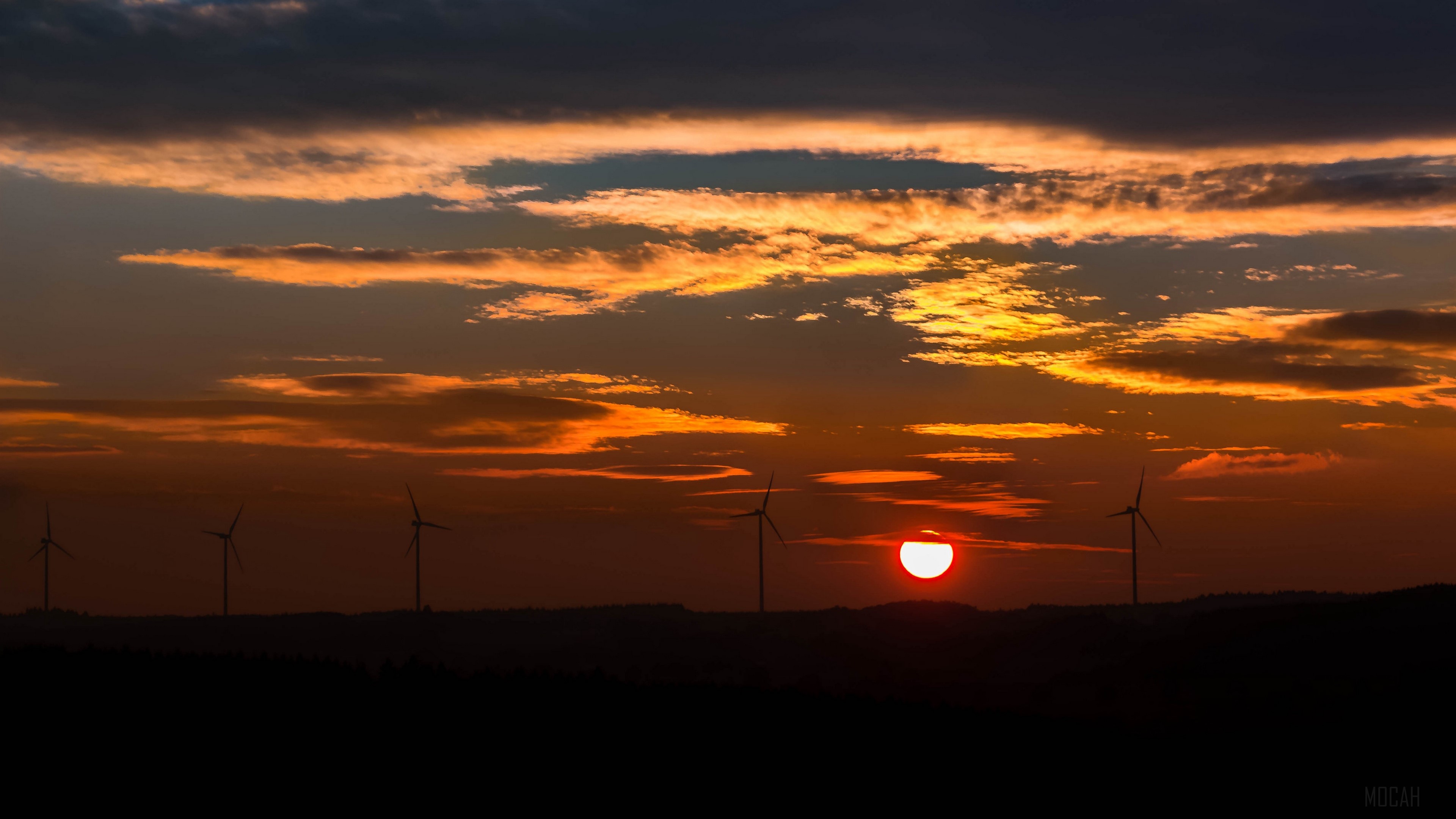 Windmills at sunset with dramatic clouds 4K HD Wallpaper