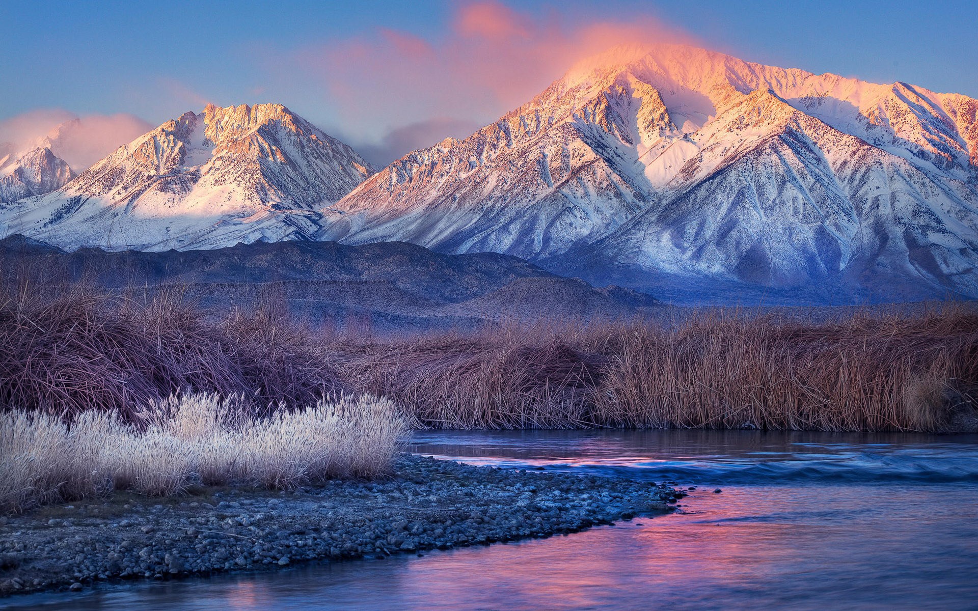 Snow-capped mountains at sunrise with a river in the foreground HD Wallpaper