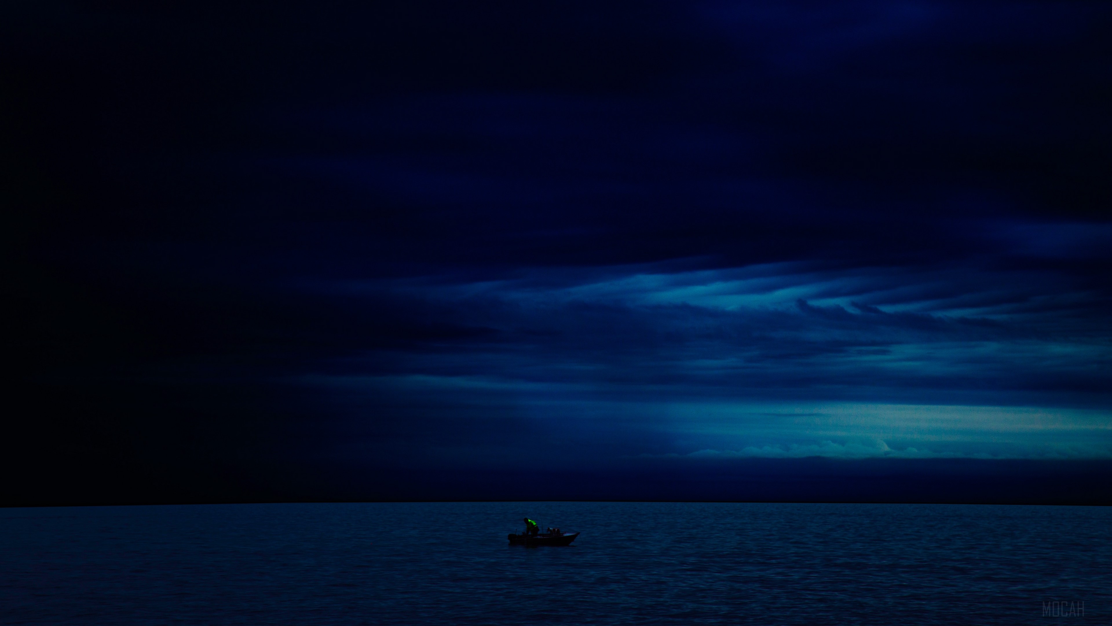 Boat on the water at night with dark clouds 4K HD Wallpaper