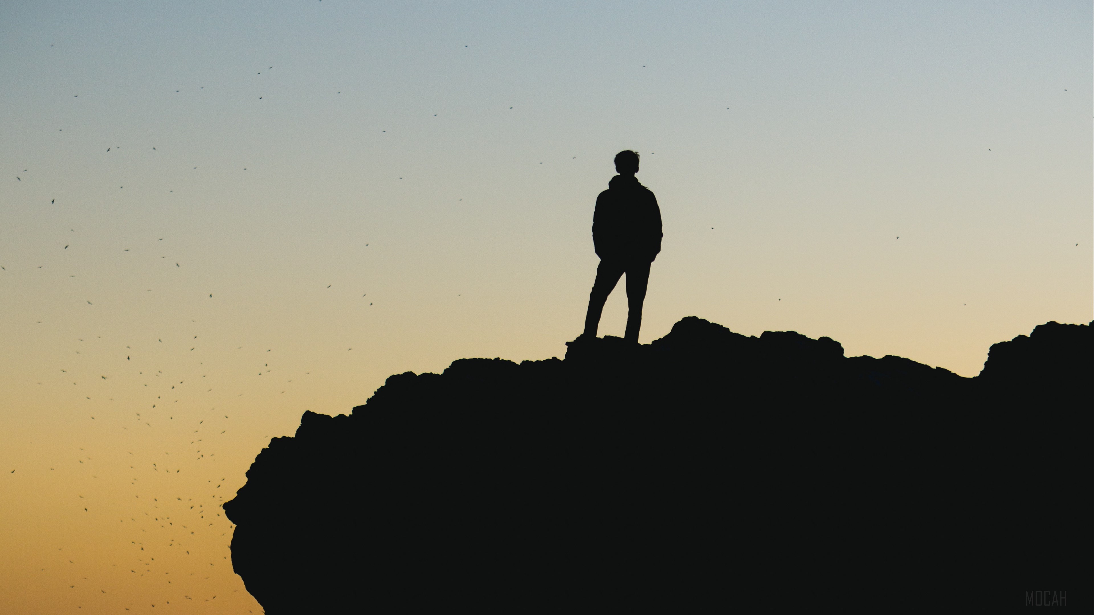 Silhouette of a person on a rock at sunset 4K HD Wallpaper