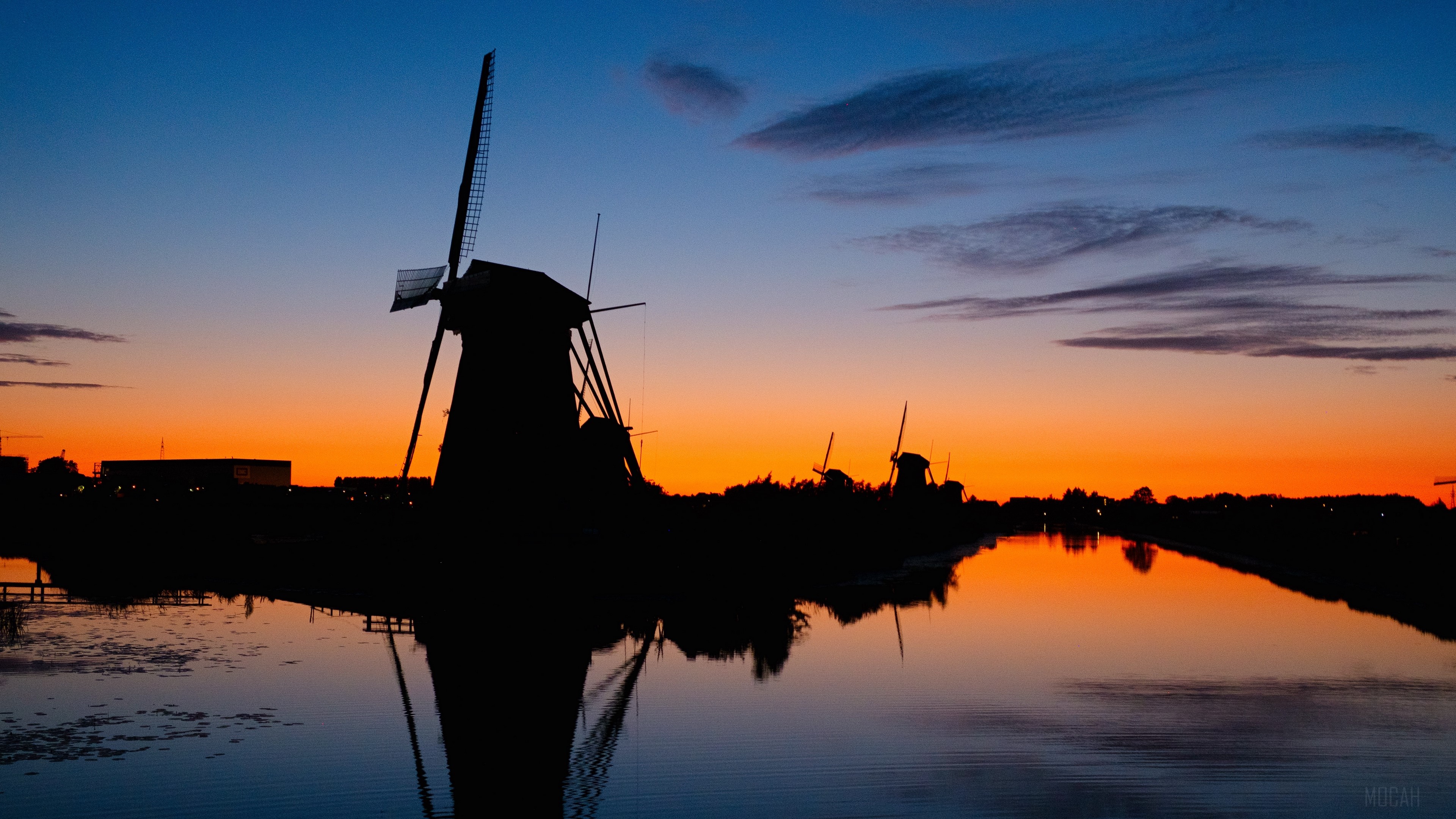Windmills silhouette at sunset over river 4K HD Wallpaper