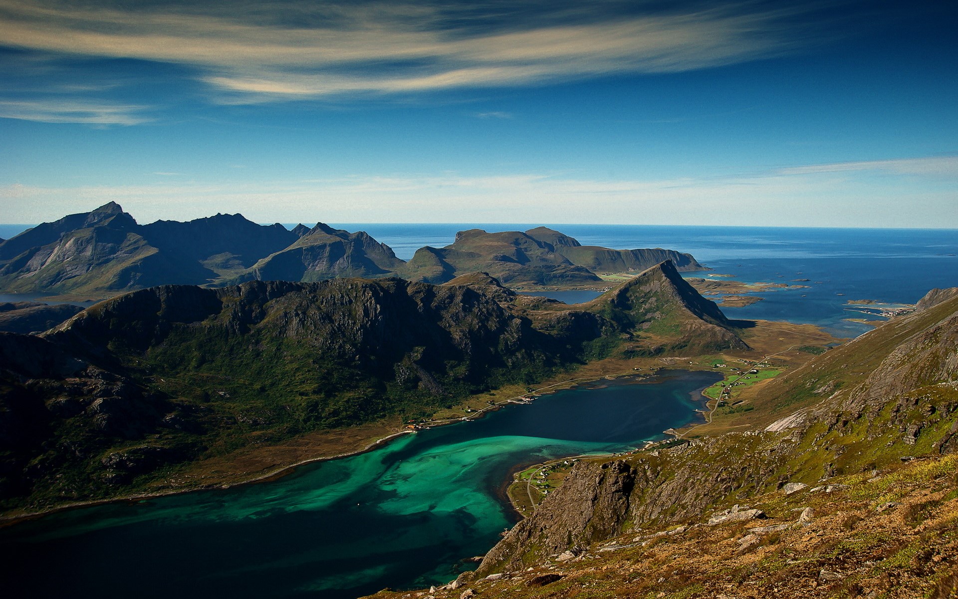 Mountainous coastline with turquoise water and blue sky HD Wallpaper