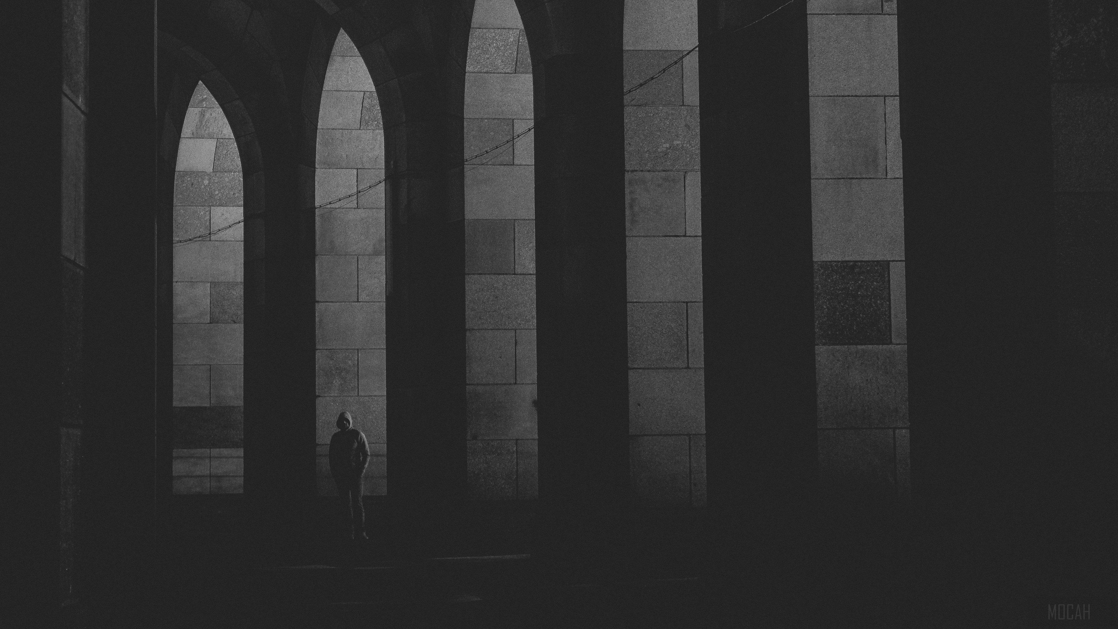 Lonely figure in stone arches, black and white 4K HD Wallpaper