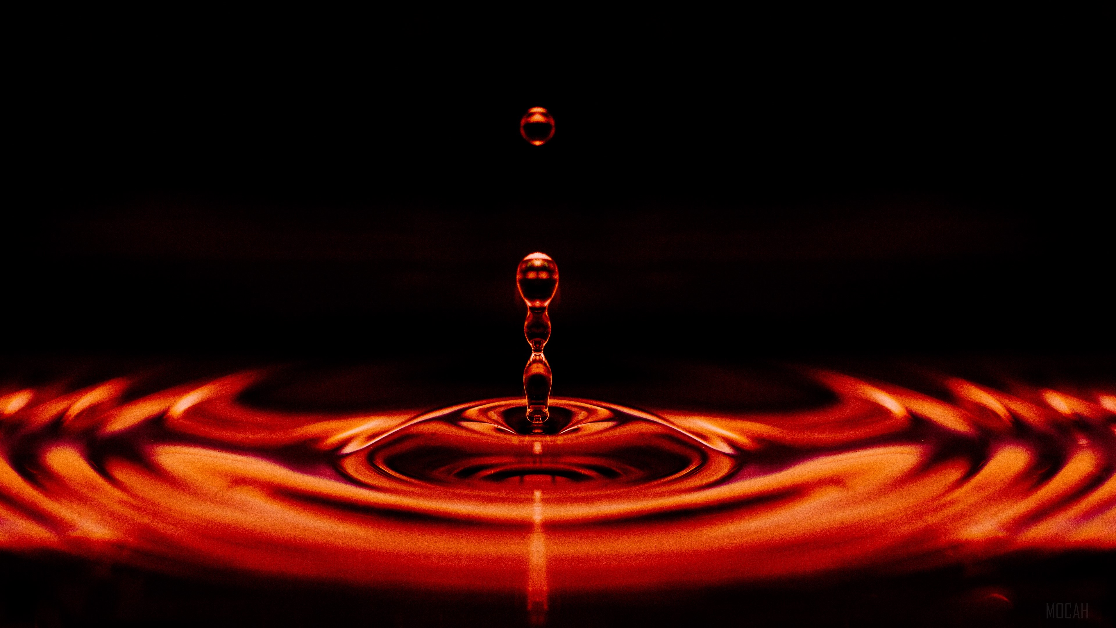 Red liquid drop creating ripples HD Wallpaper