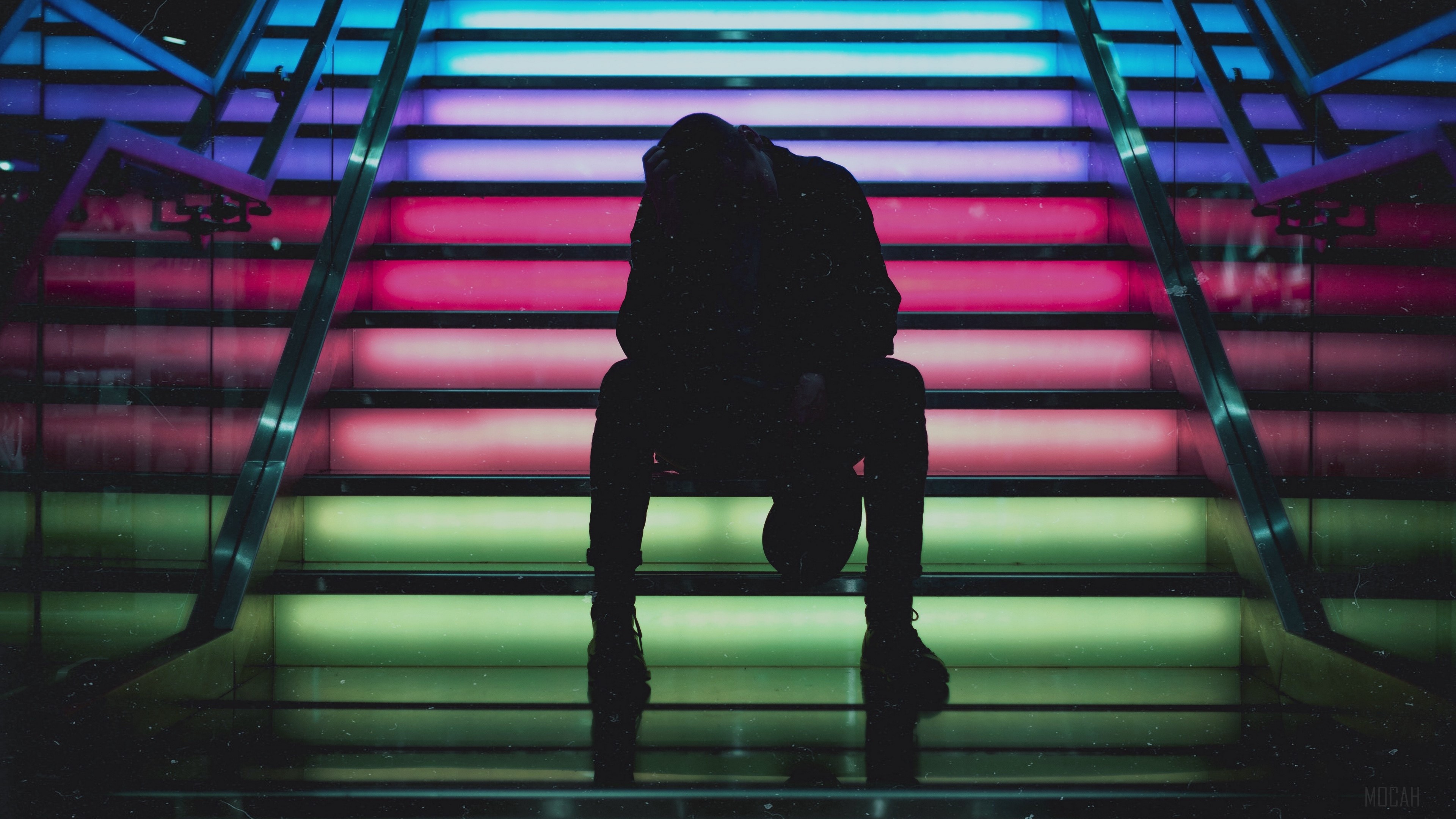 Man sitting on colorful illuminated stairs HD Wallpaper