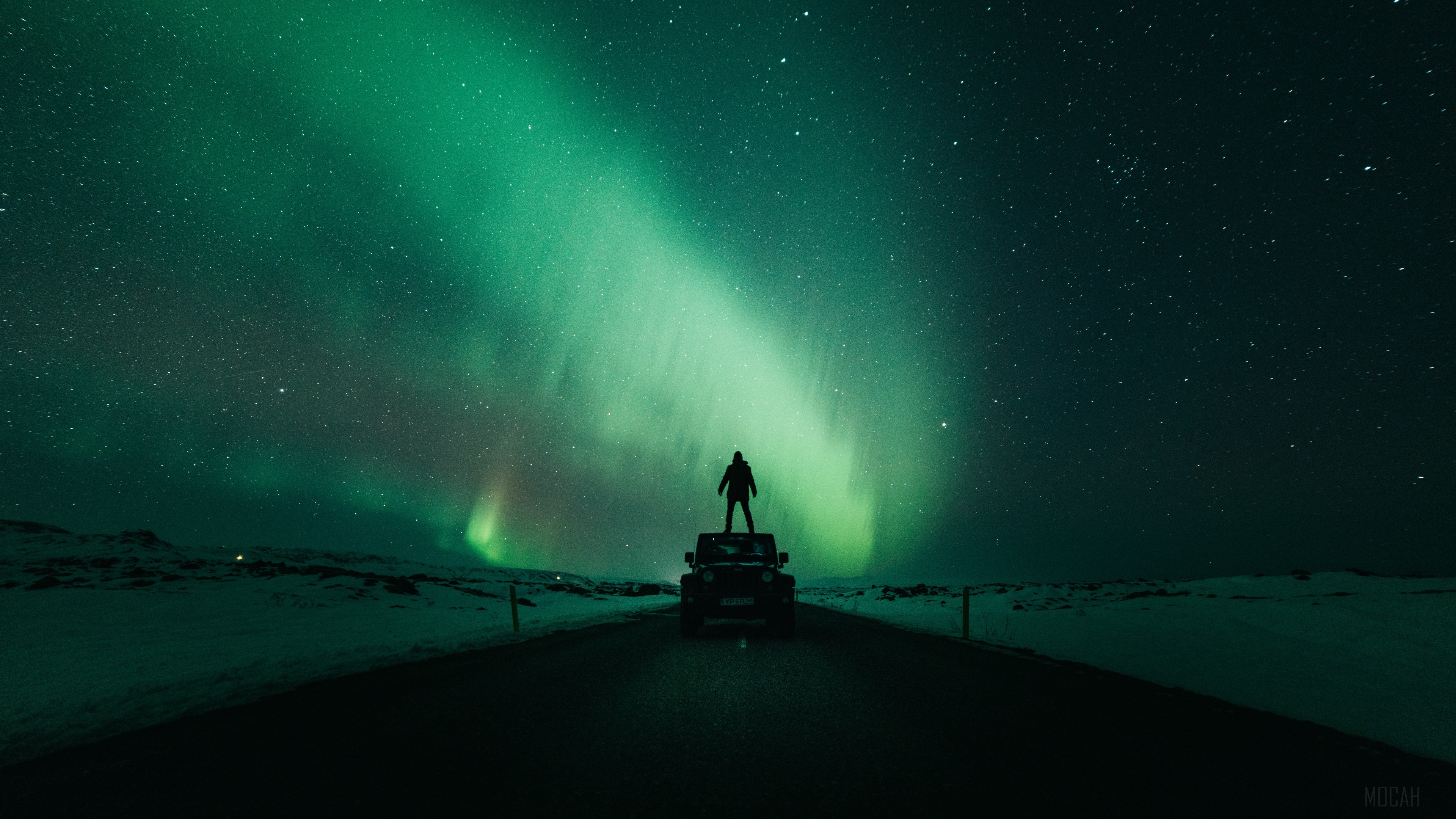 Man on car under aurora borealis HD Wallpaper