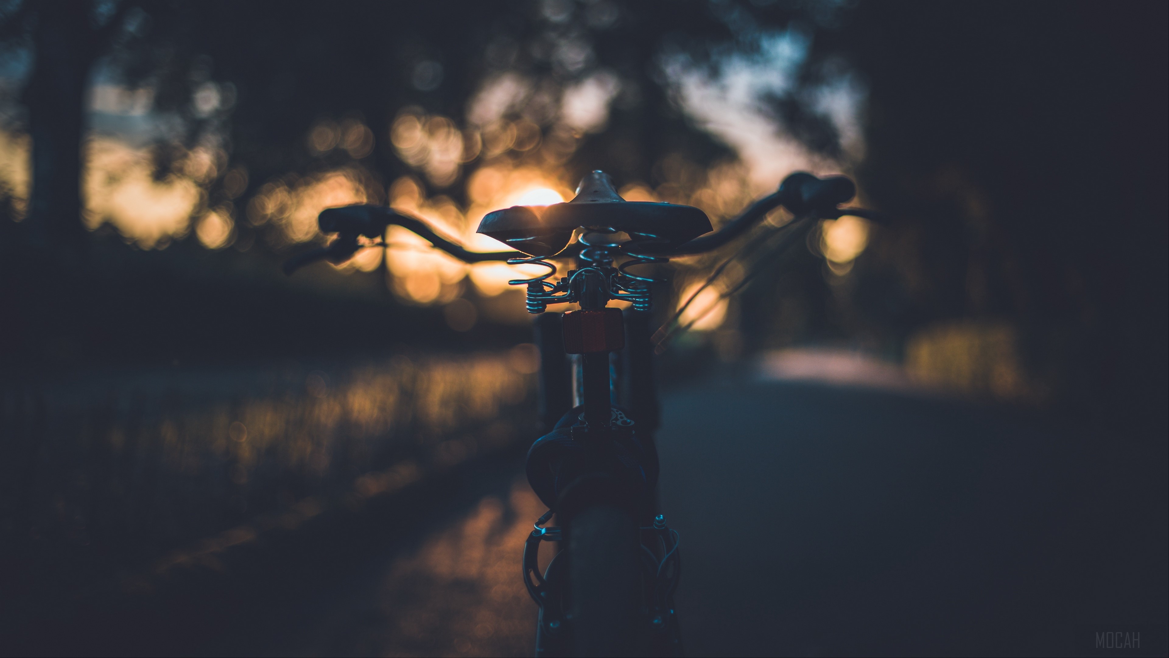 Bicycle seat at sunset HD Wallpaper