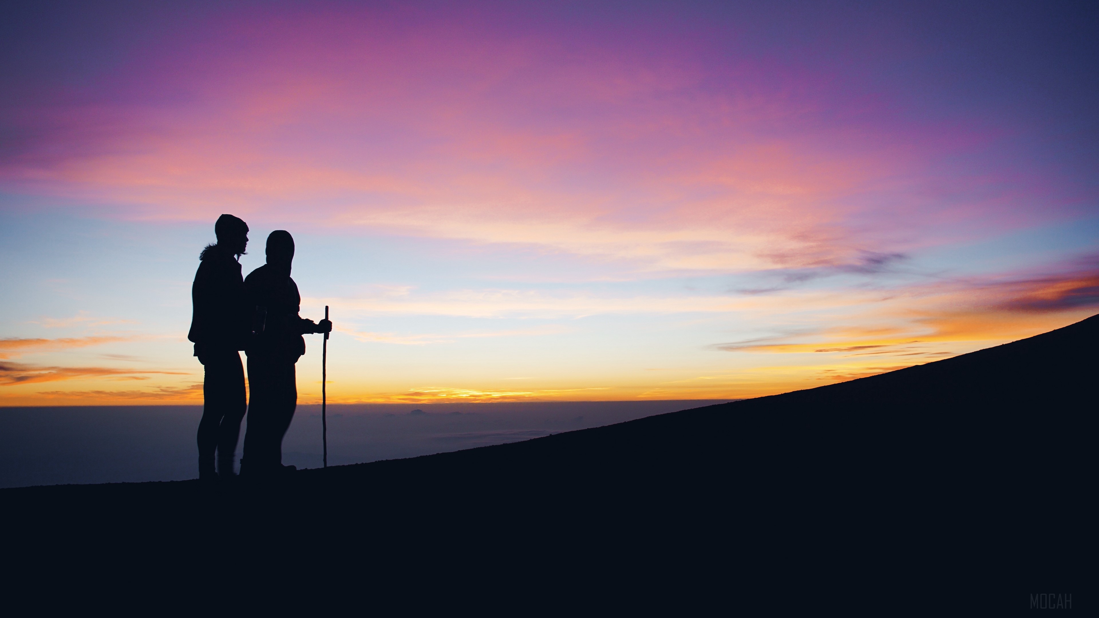 Silhouettes of two hikers at sunrise on a mountain 4K HD Wallpaper