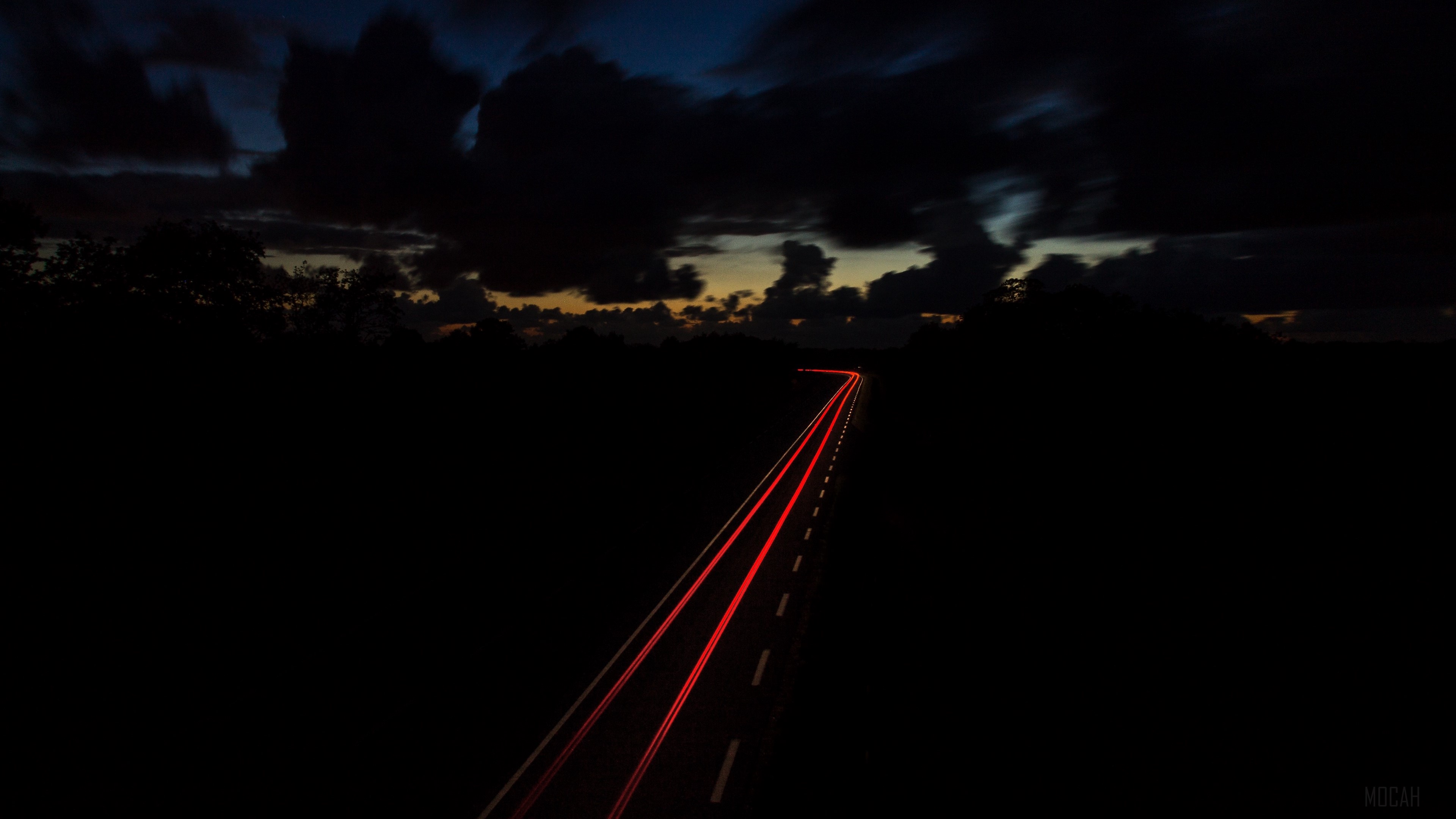 Road at night with light trails and dark sky HD Wallpaper