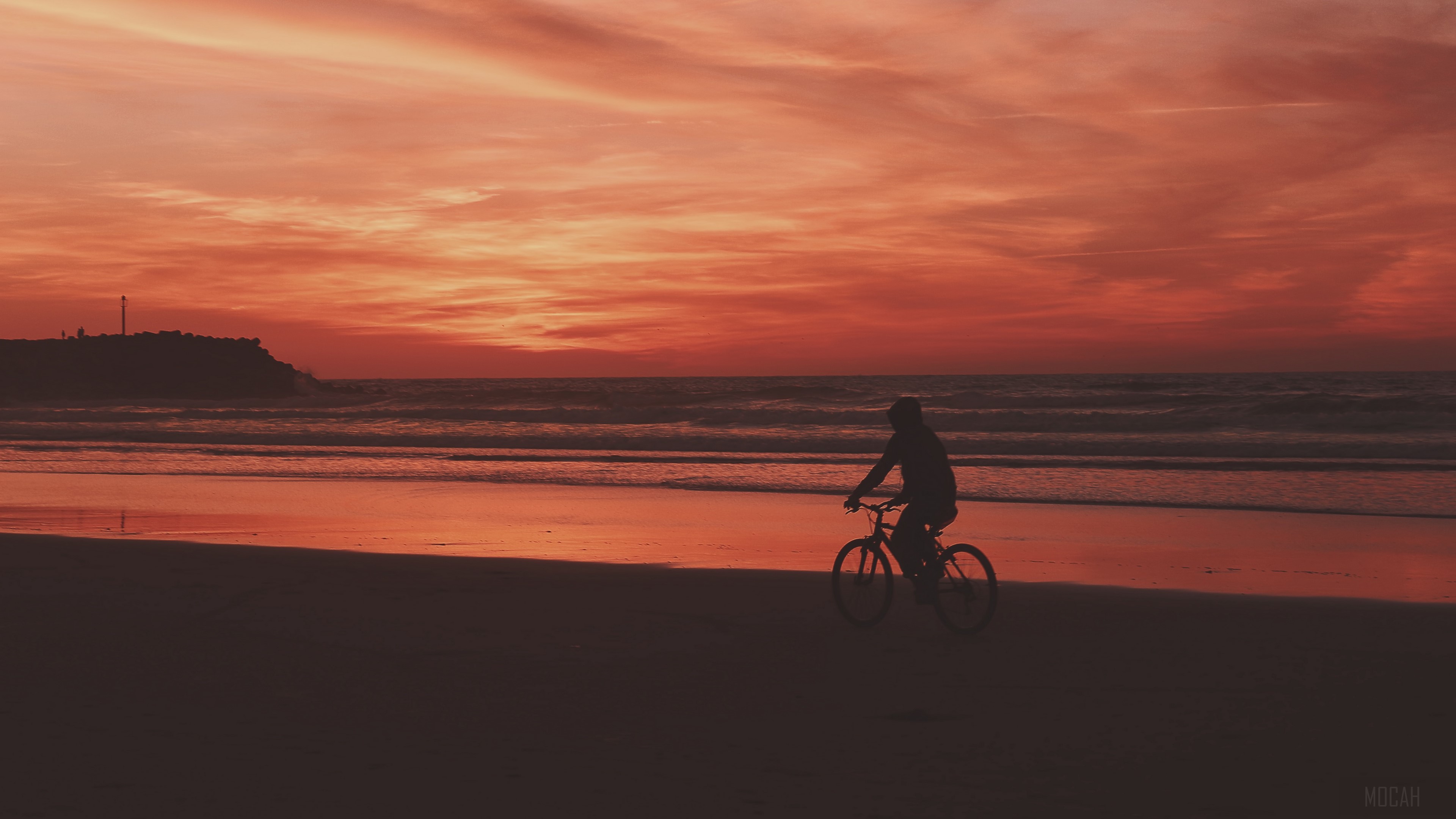 Bicyclist on beach at sunset 4K HD Wallpaper