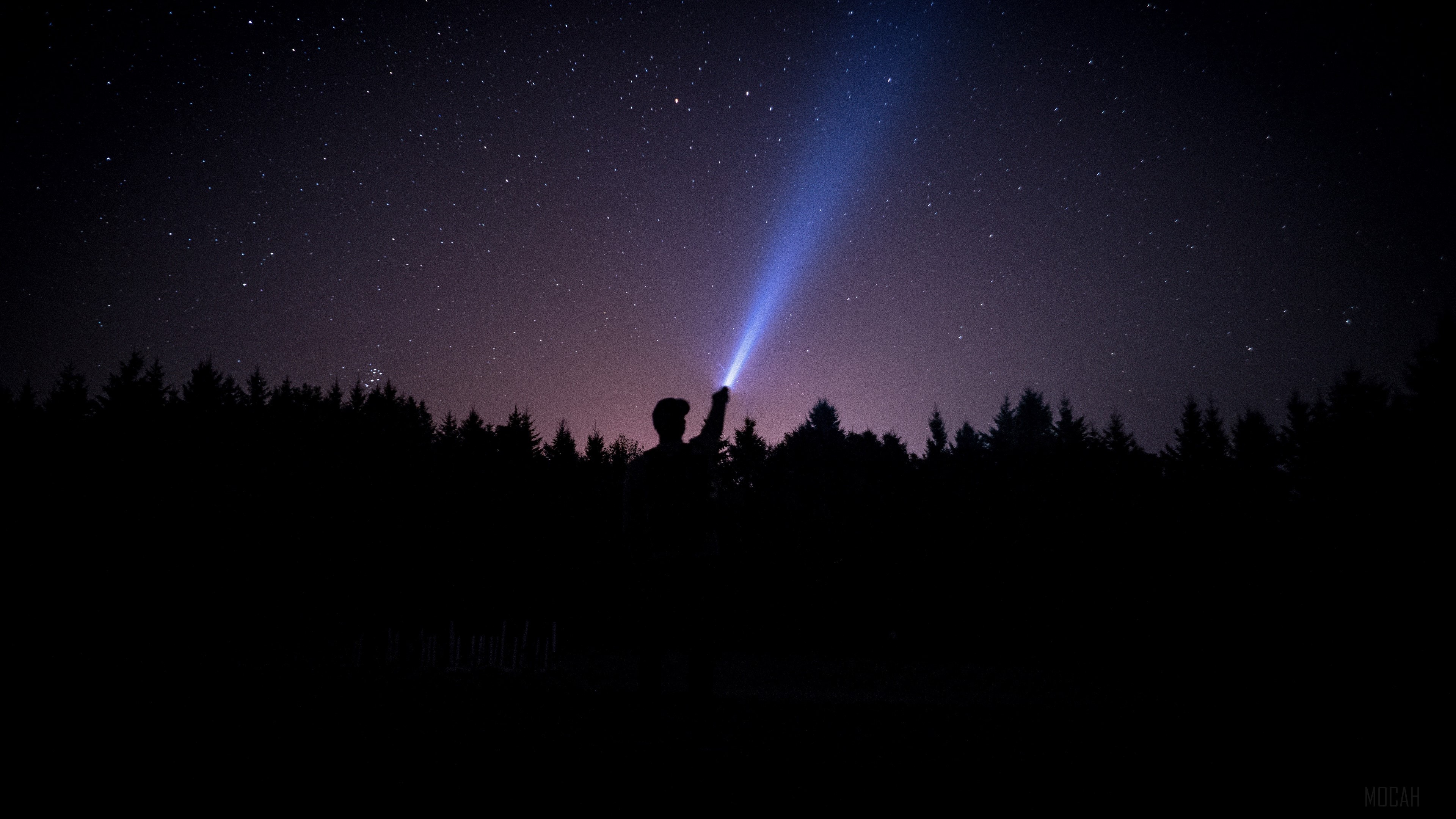 Man with flashlight under starry sky HD Wallpaper