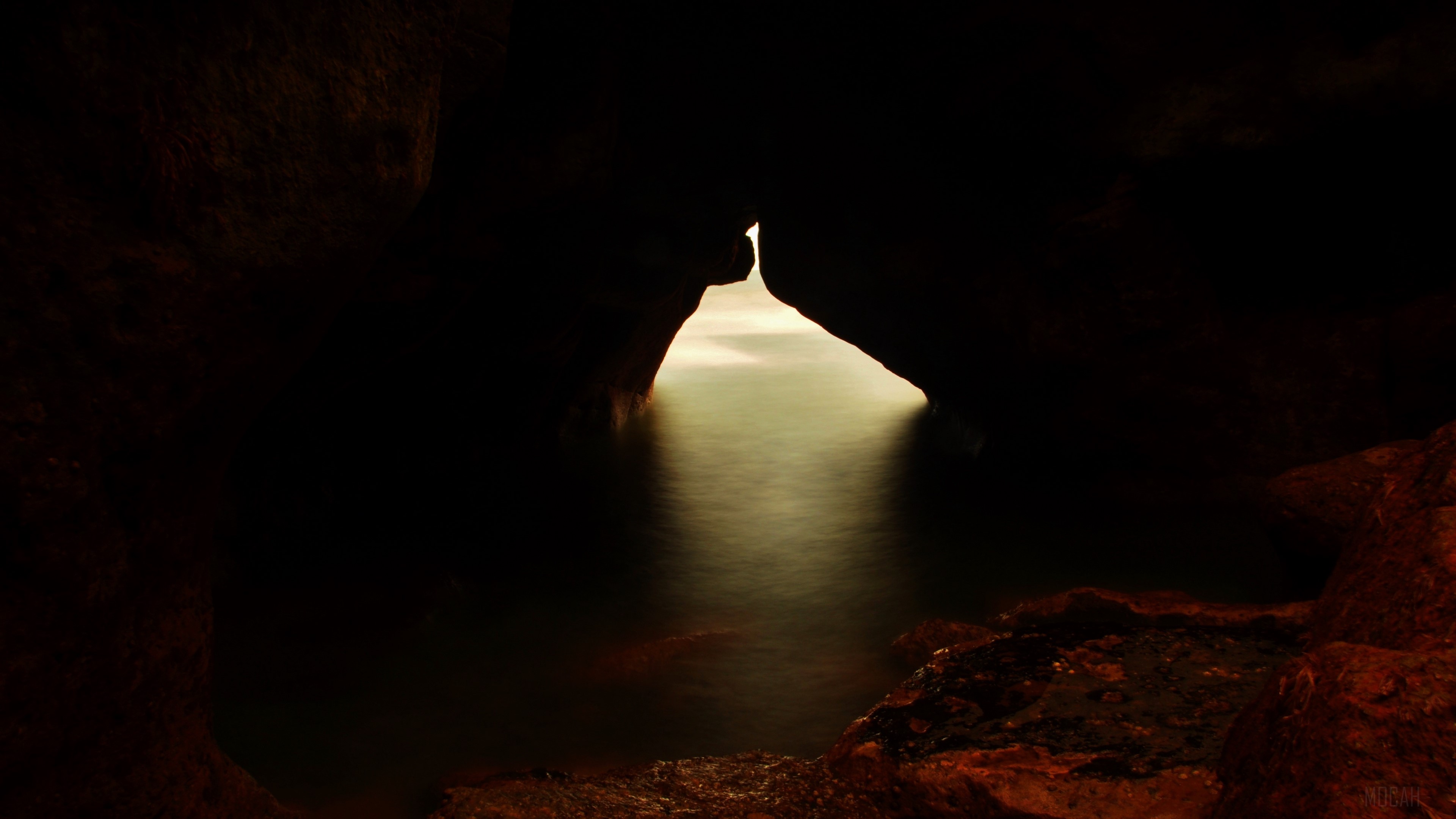 Cave entrance with water and light HD Wallpaper