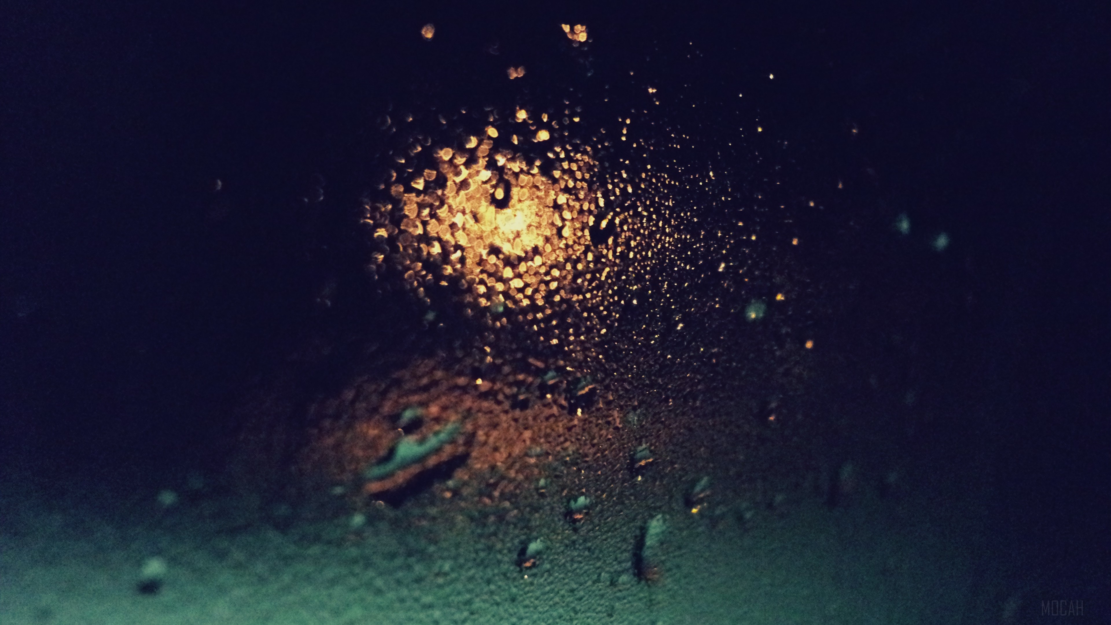 Raindrops on glass with light at night 4K HD Wallpaper