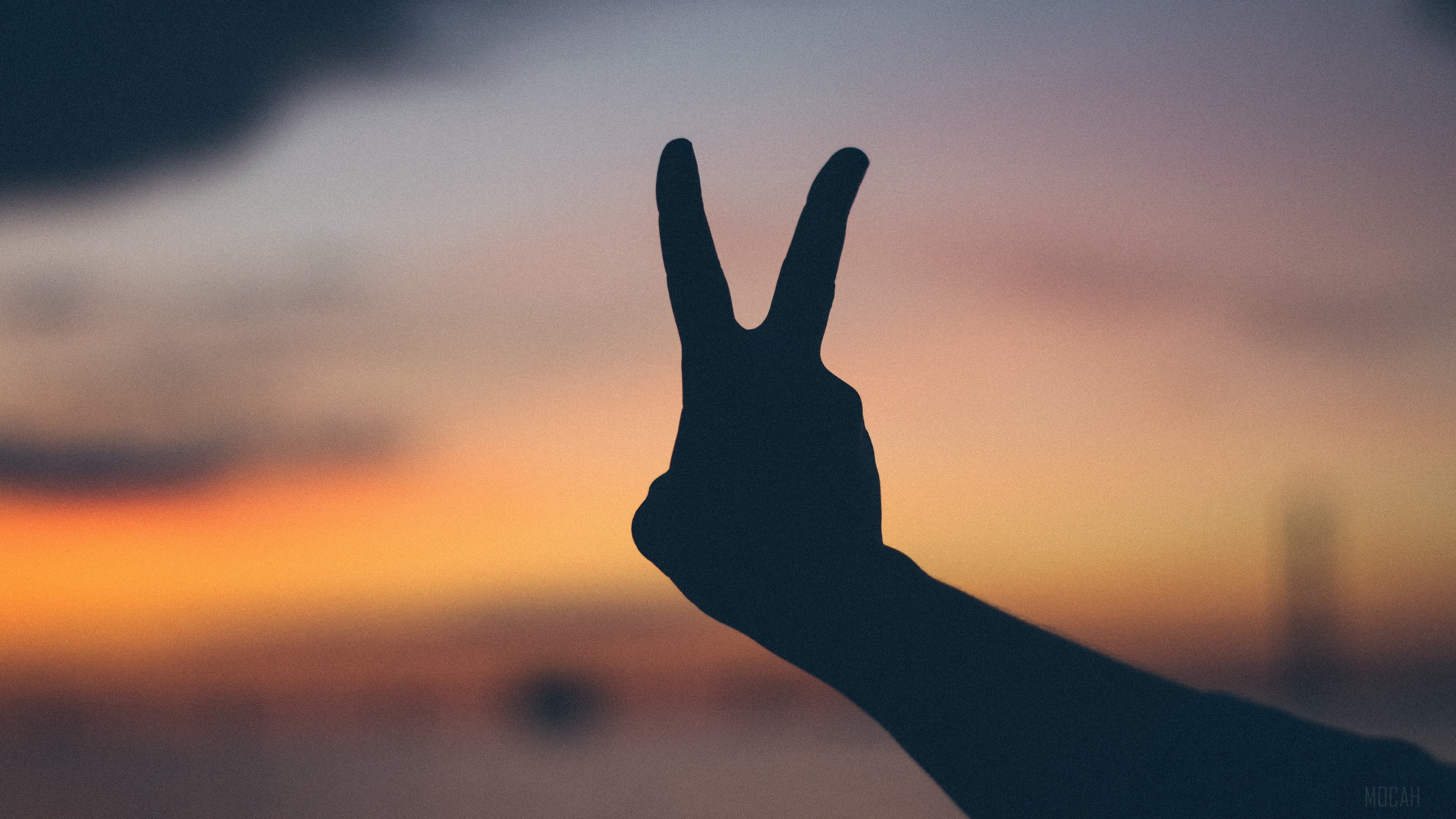 Silhouette of a hand making a peace sign at sunset 4K HD Wallpaper