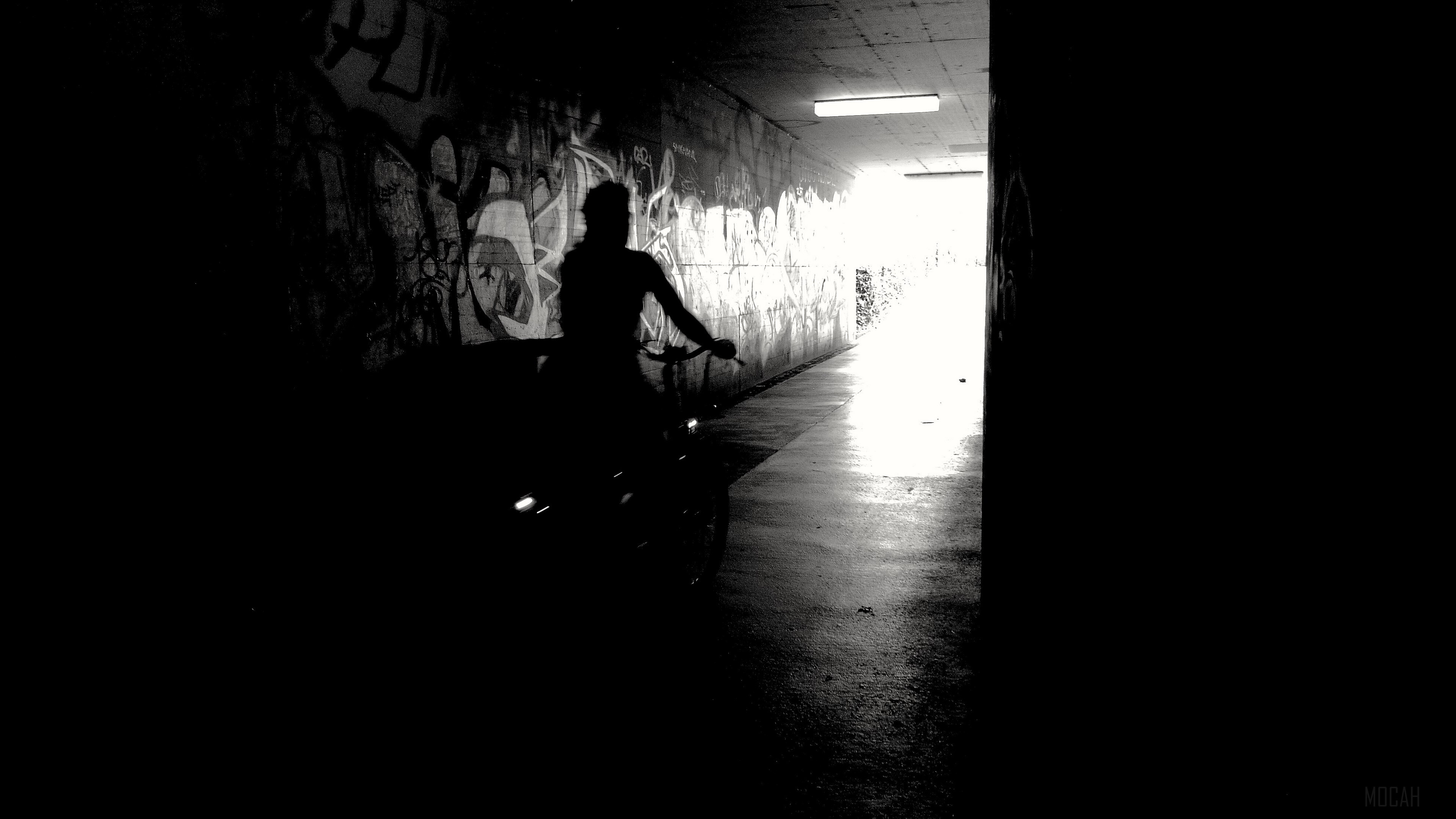 Bicyclist in tunnel with graffiti 4K HD Wallpaper
