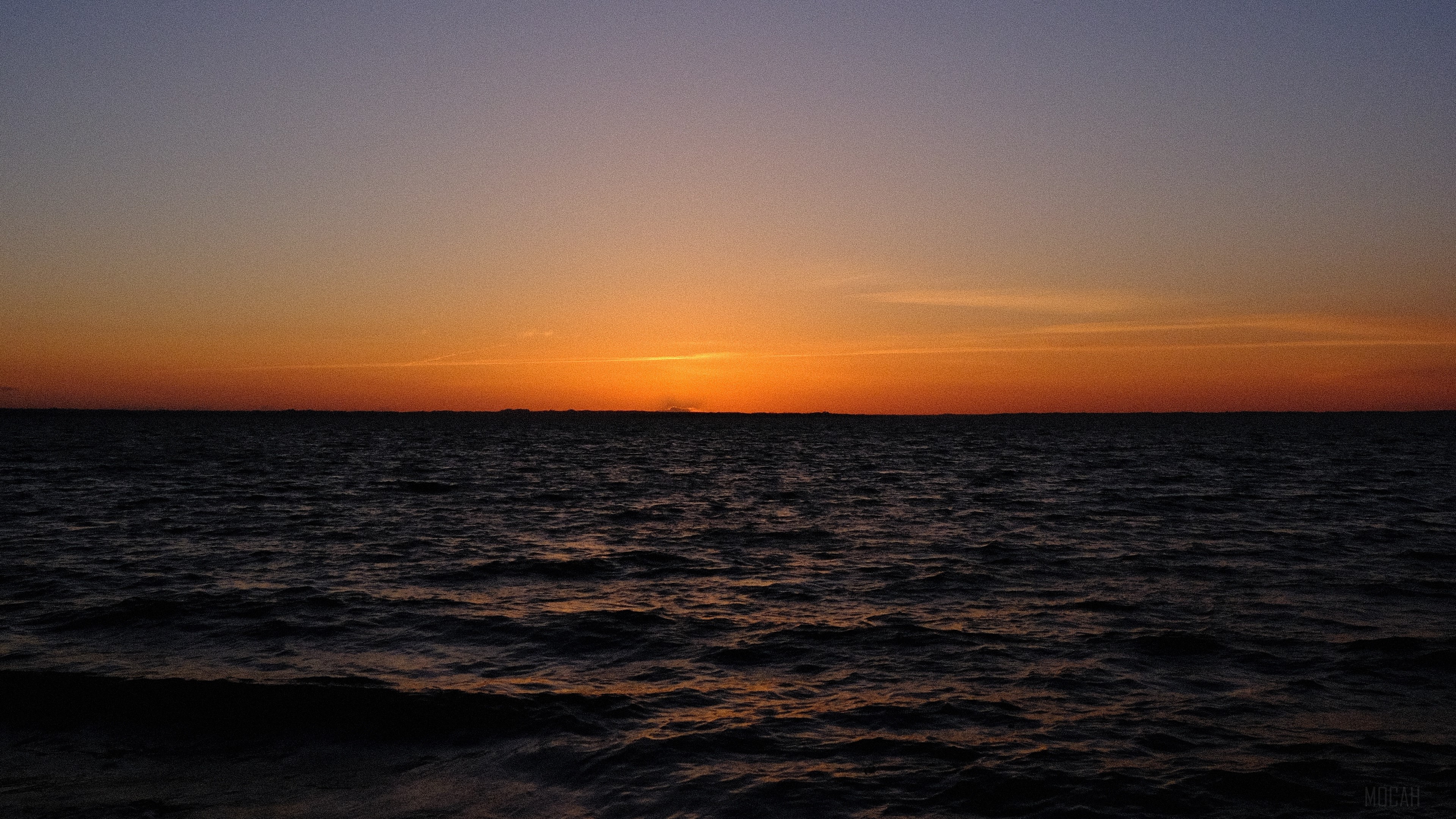Sunset over the dark sea horizon 4K HD Wallpaper