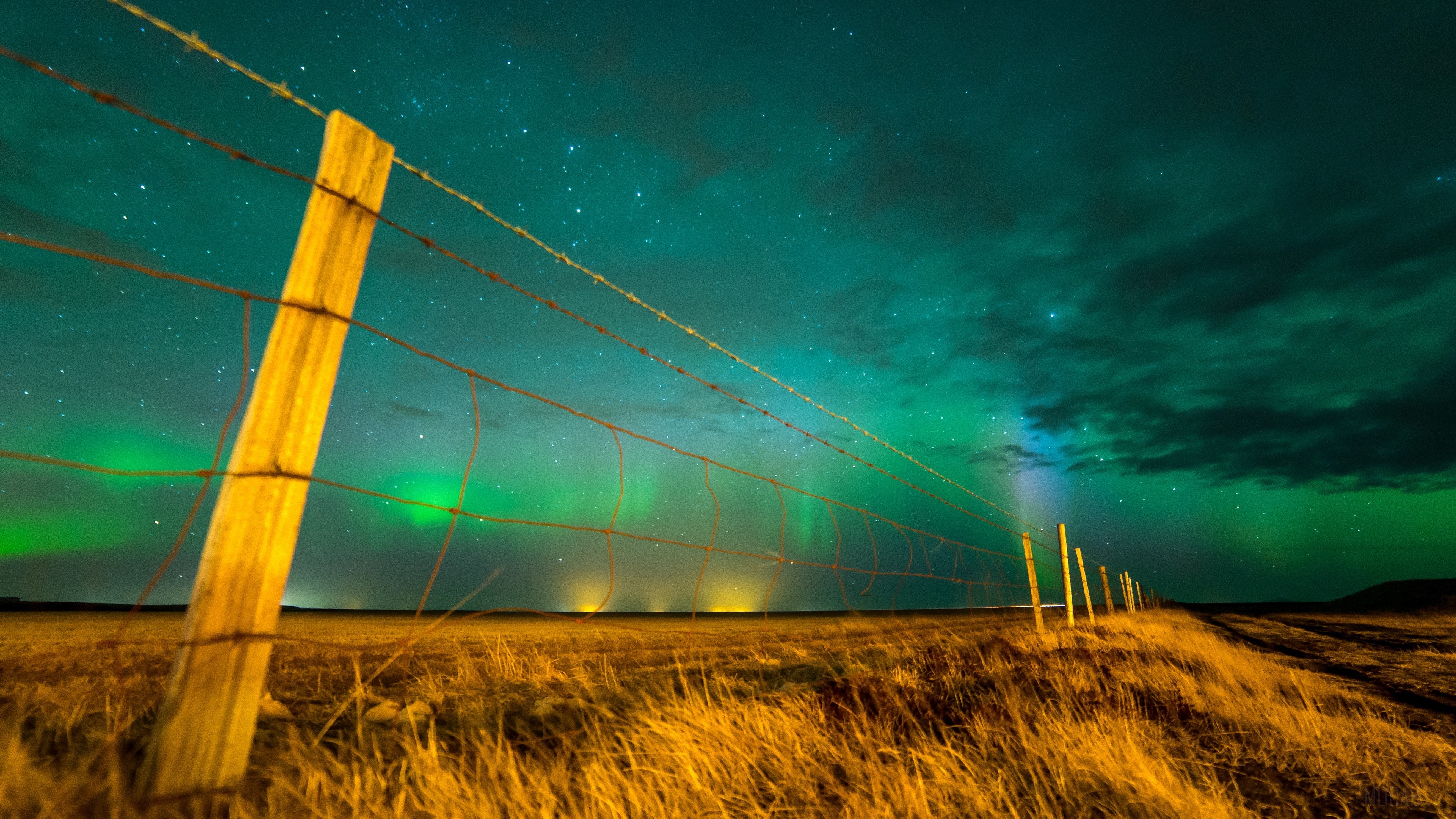 Northern Lights over a field with fence HD Wallpaper