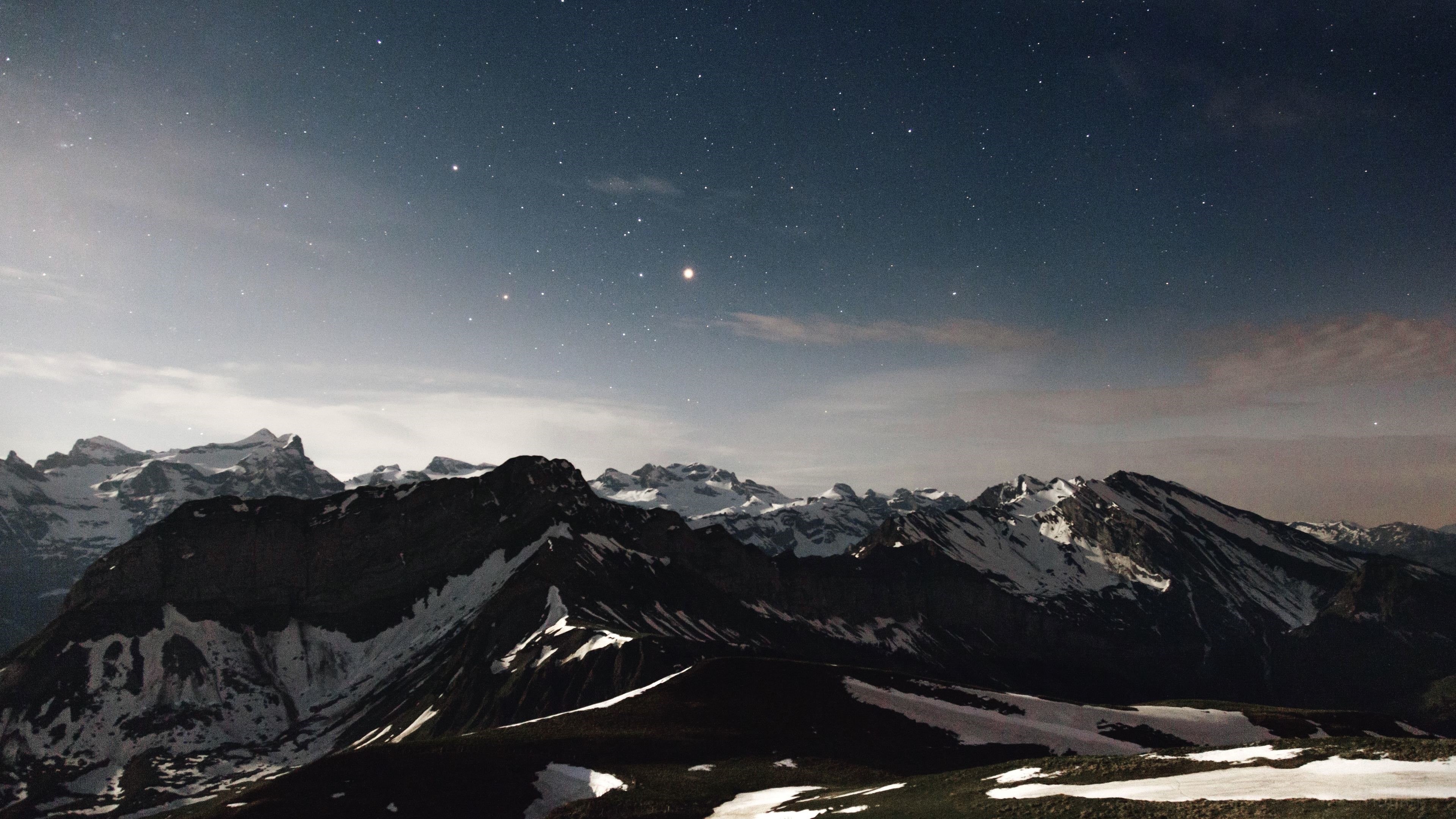 Starry Night Sky Over Snow-Capped Mountains 4K HD Wallpaper