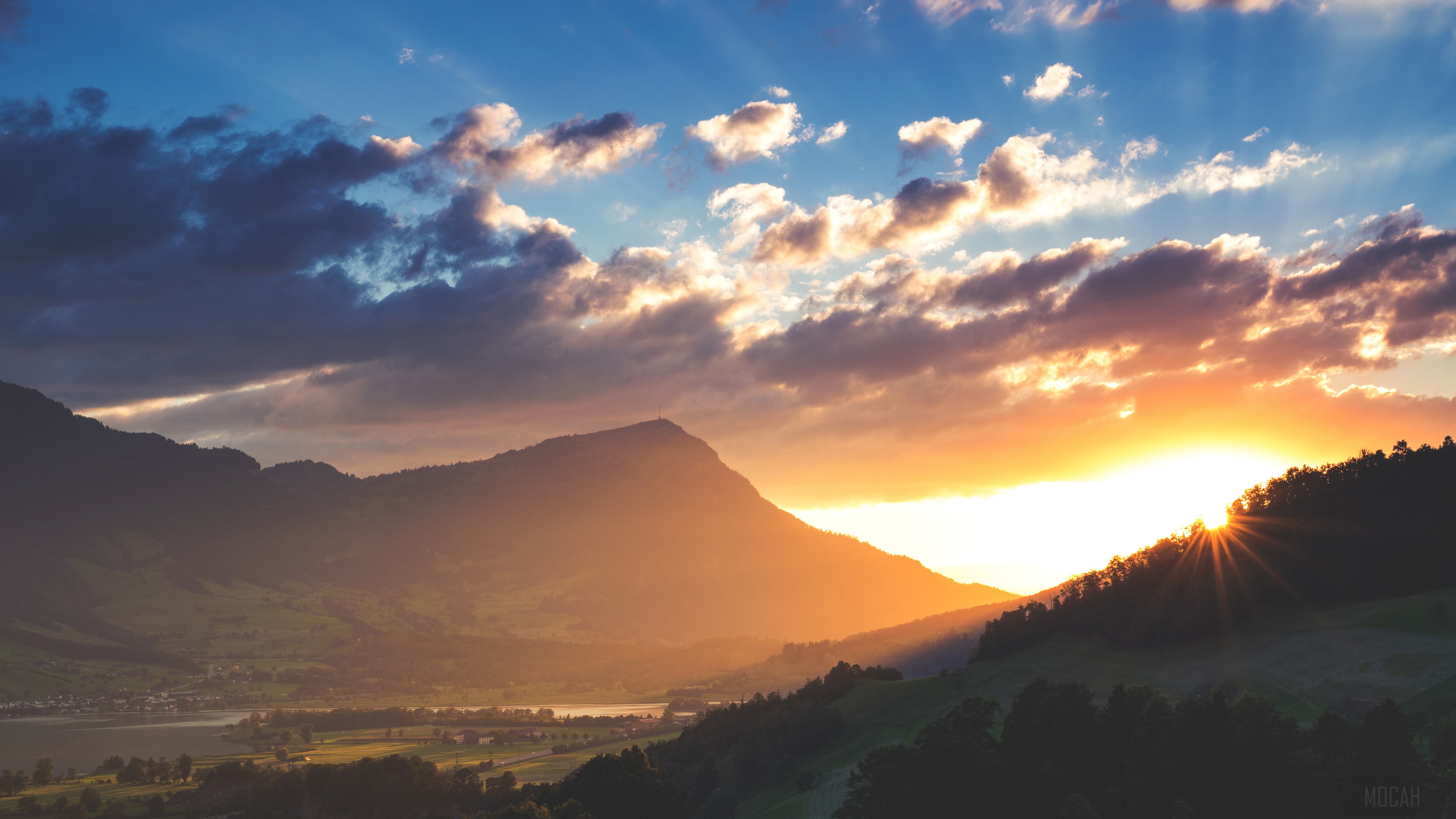 Sunbeams over mountains and valley at sunset 4k HD Wallpaper