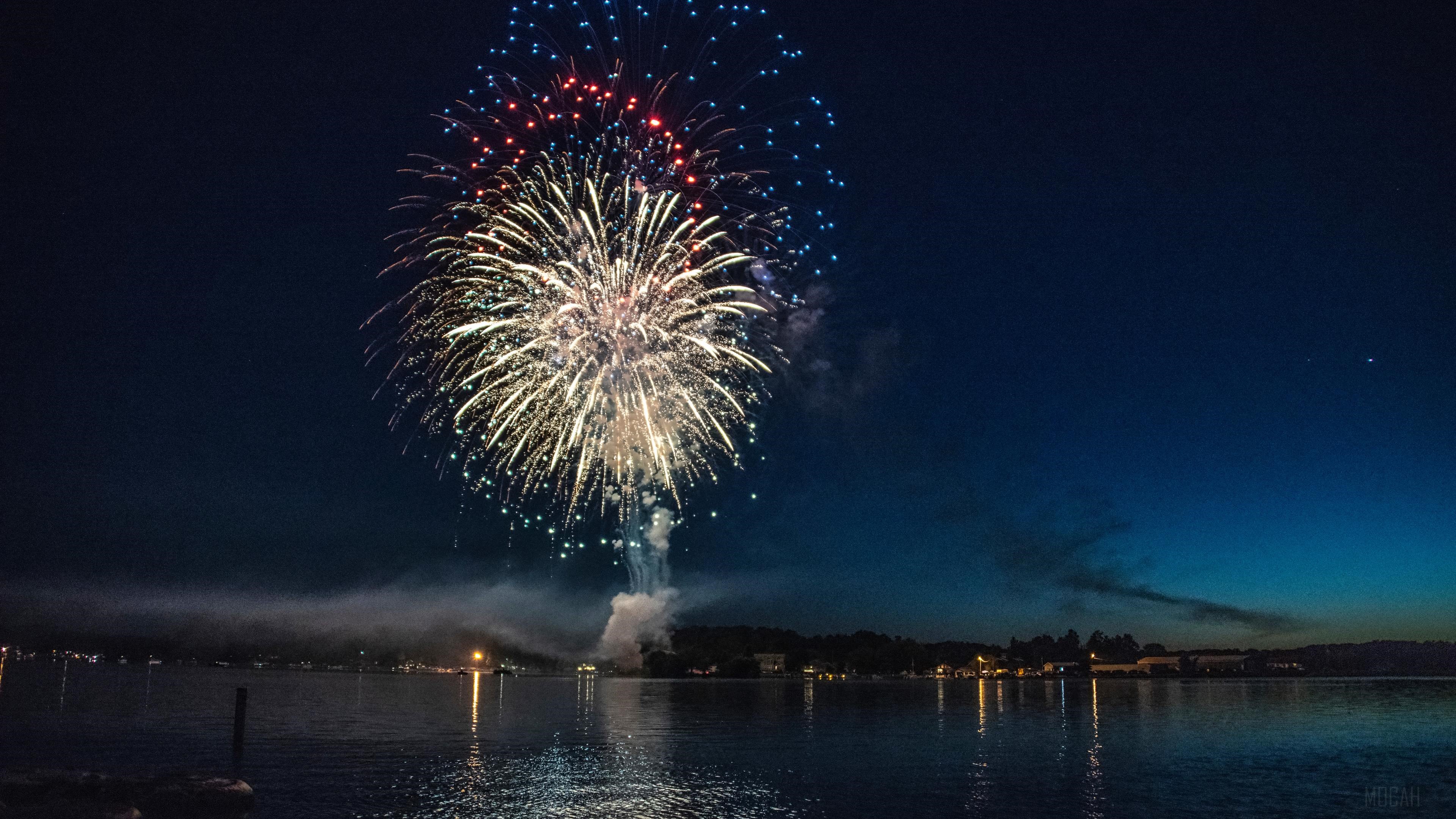 Fireworks Explosion Over Water Body 4K HD Wallpaper