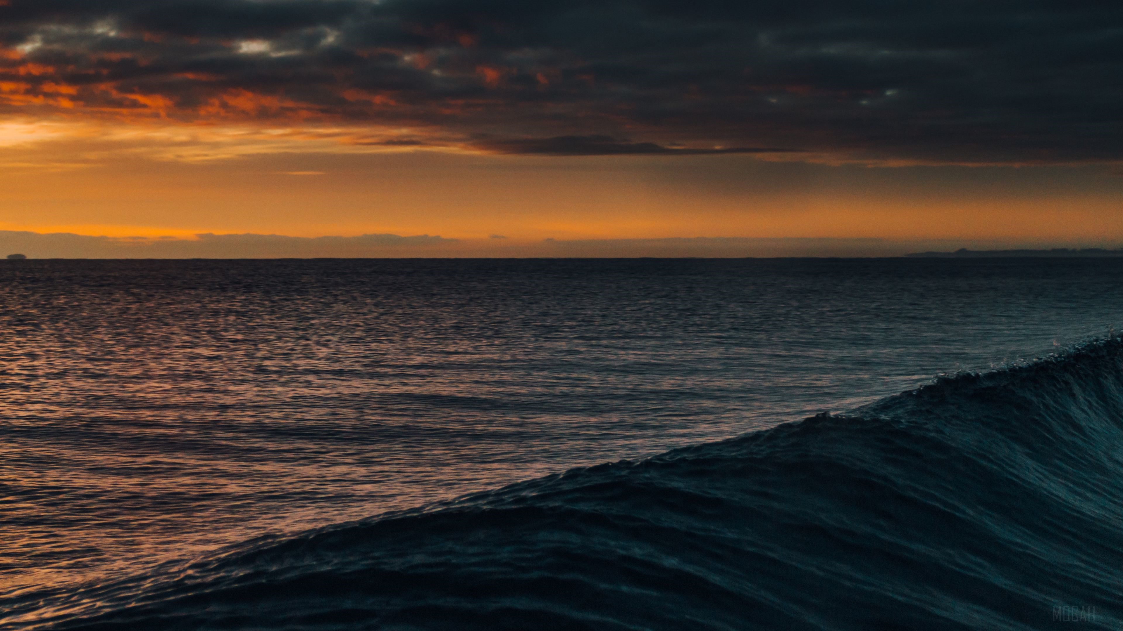 Dark Orange Sunset Over Ocean Waves 4K HD Wallpaper