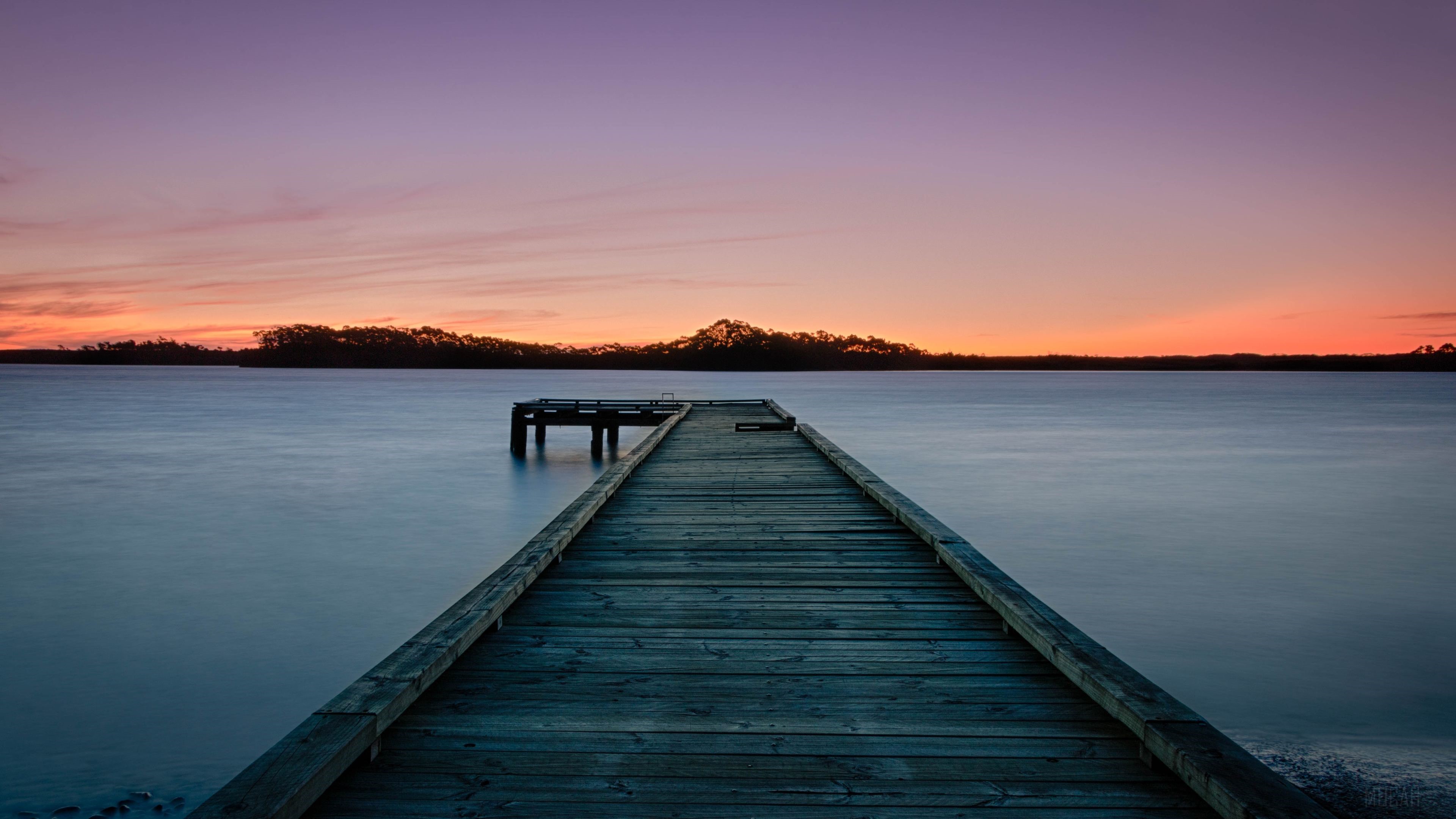 Sunset over water with a wooden pier HD Wallpaper
