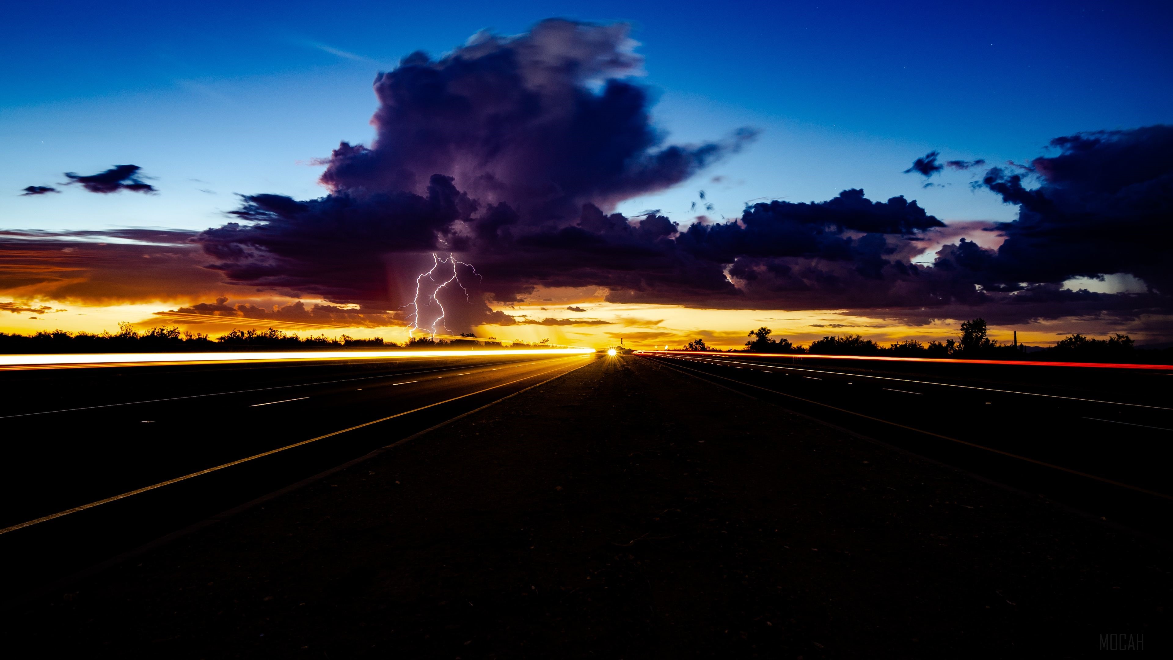 Lightning Strikes Over Highway at Sunset with Light Trails 4K HD Wallpaper