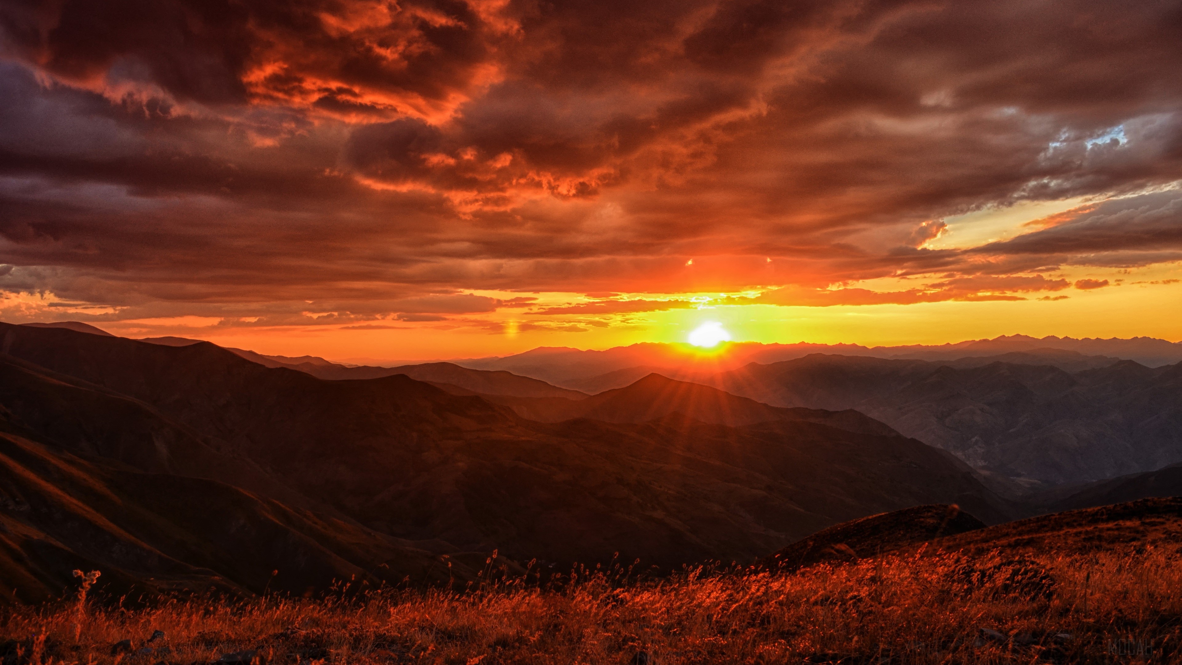Sunset over mountains with dramatic clouds HD Wallpaper