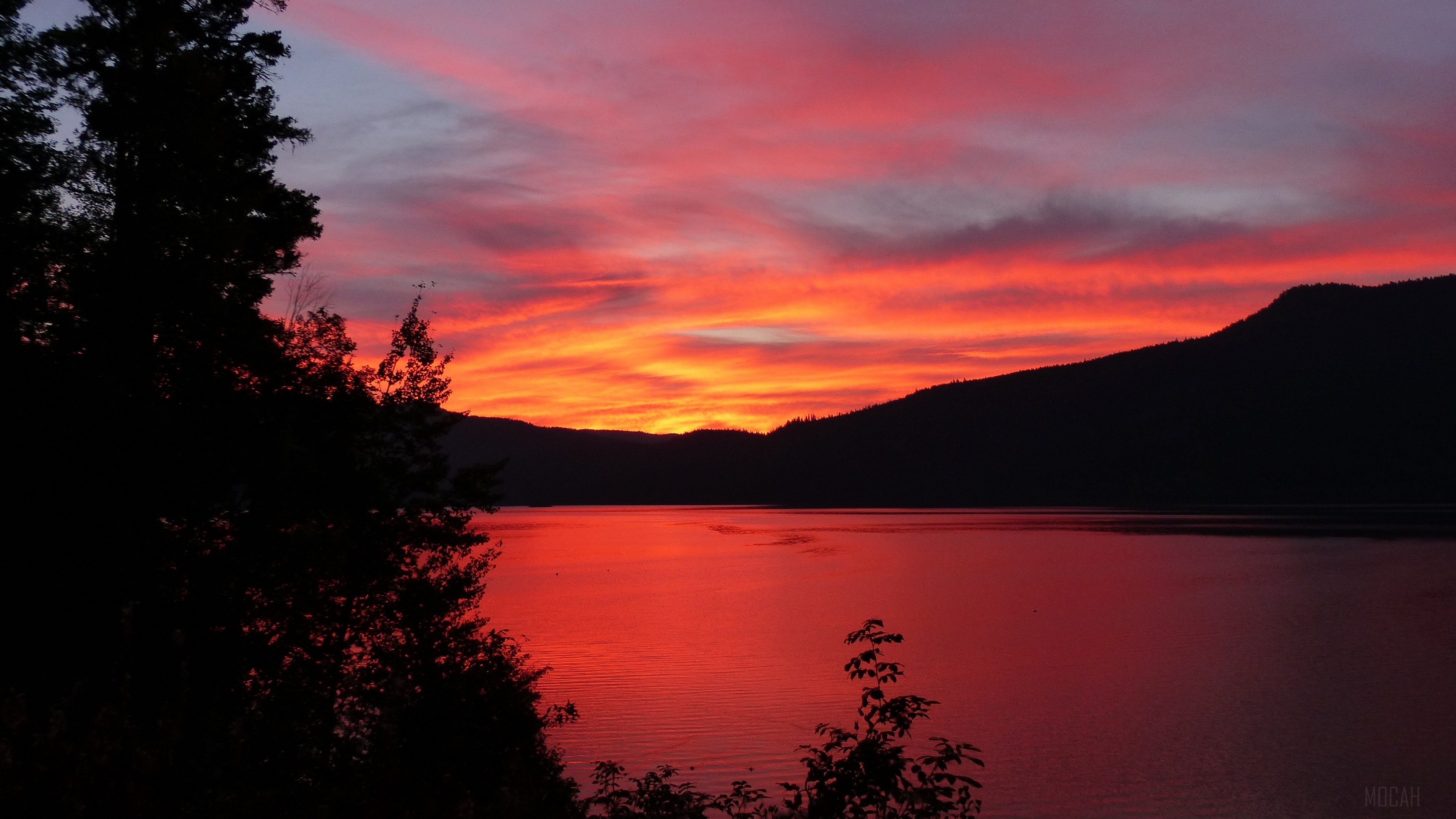 Sunset over a calm lake with mountains and trees HD Wallpaper