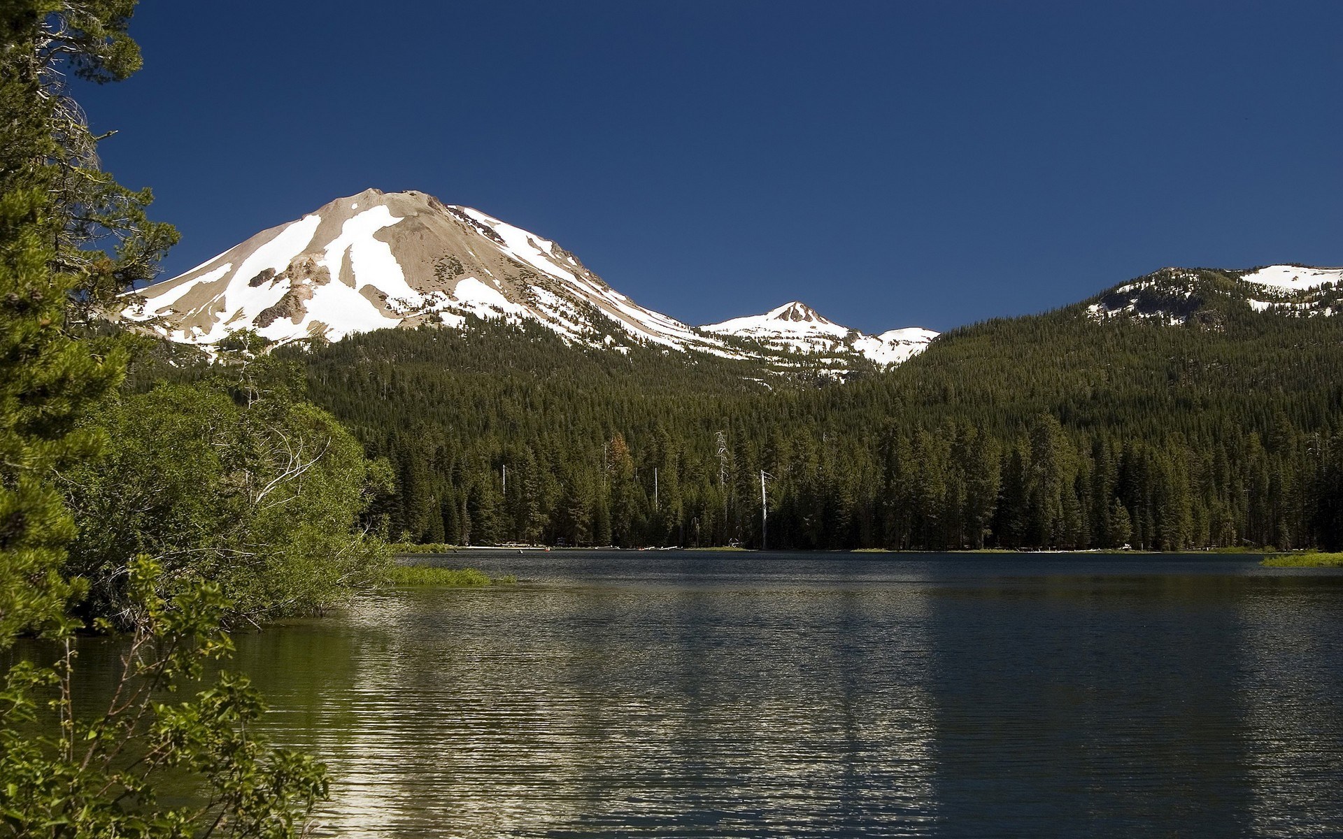 Lake with snow-capped mountains and forest HD Wallpaper