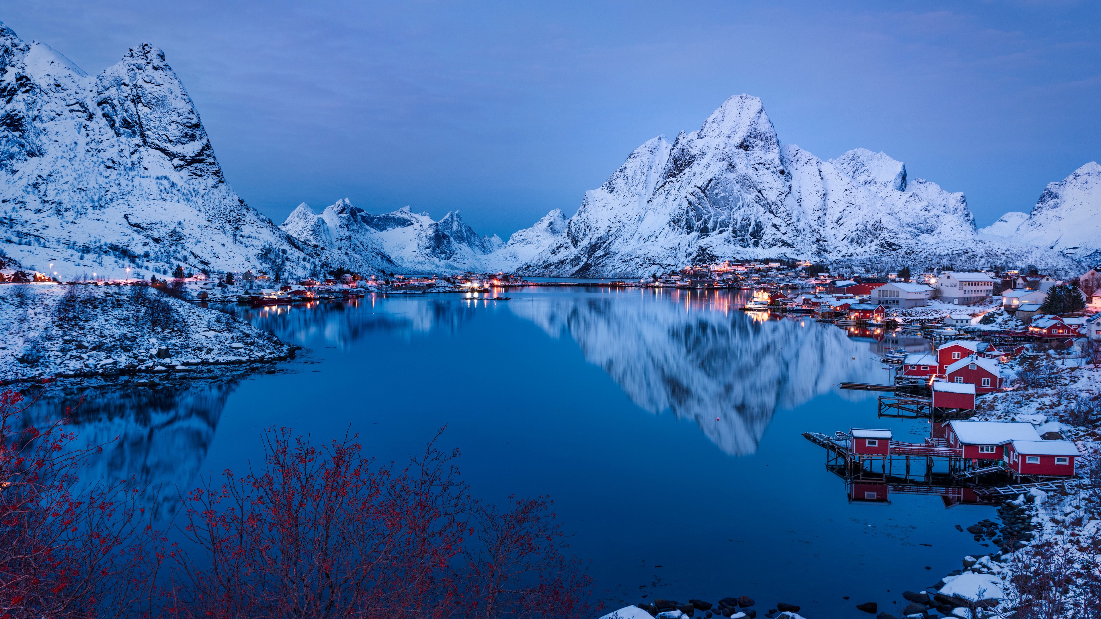 Winter village with snow-capped mountains and reflection HD Wallpaper