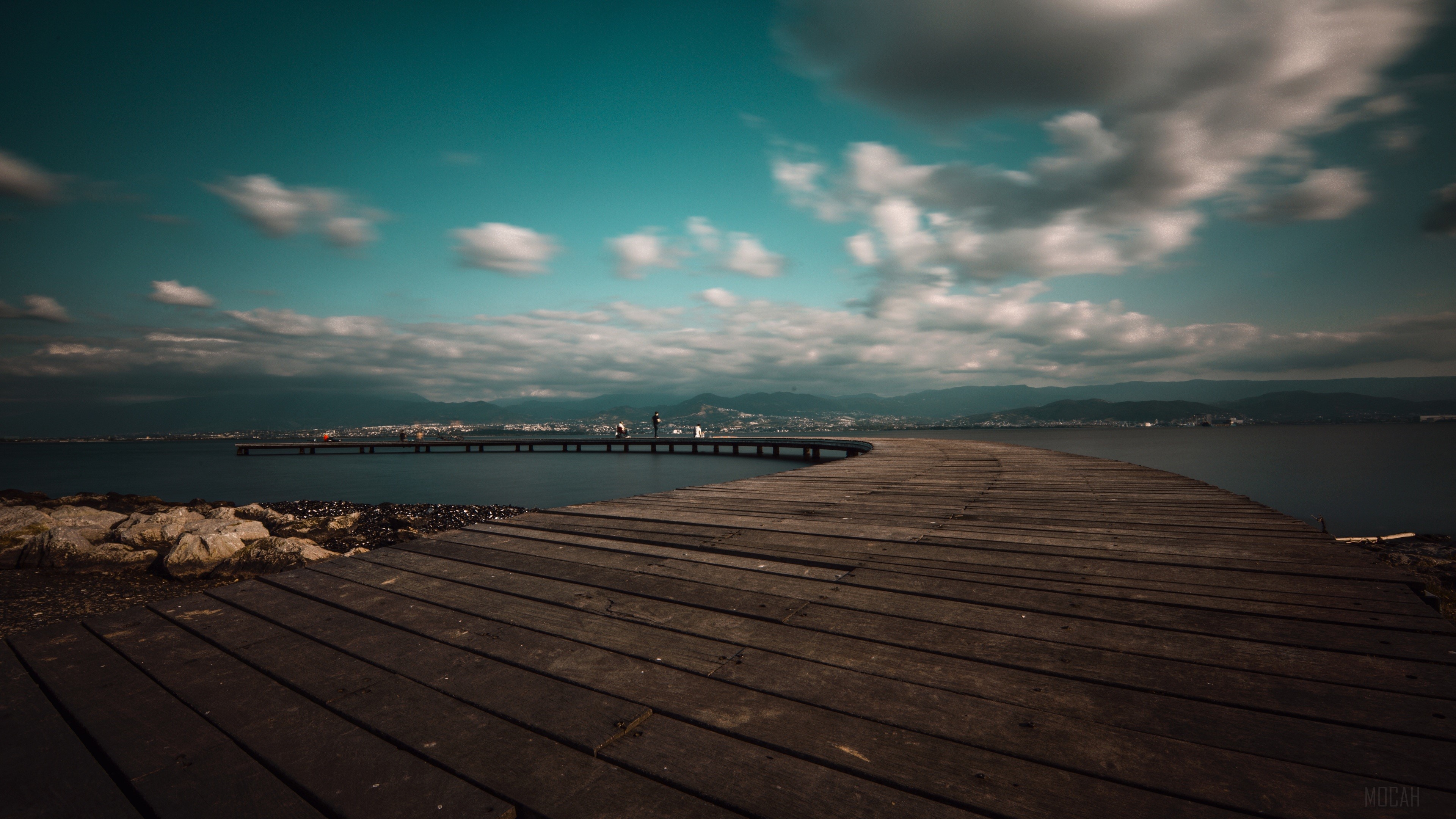 Wooden pier on a lake with mountains in the background HD Wallpaper