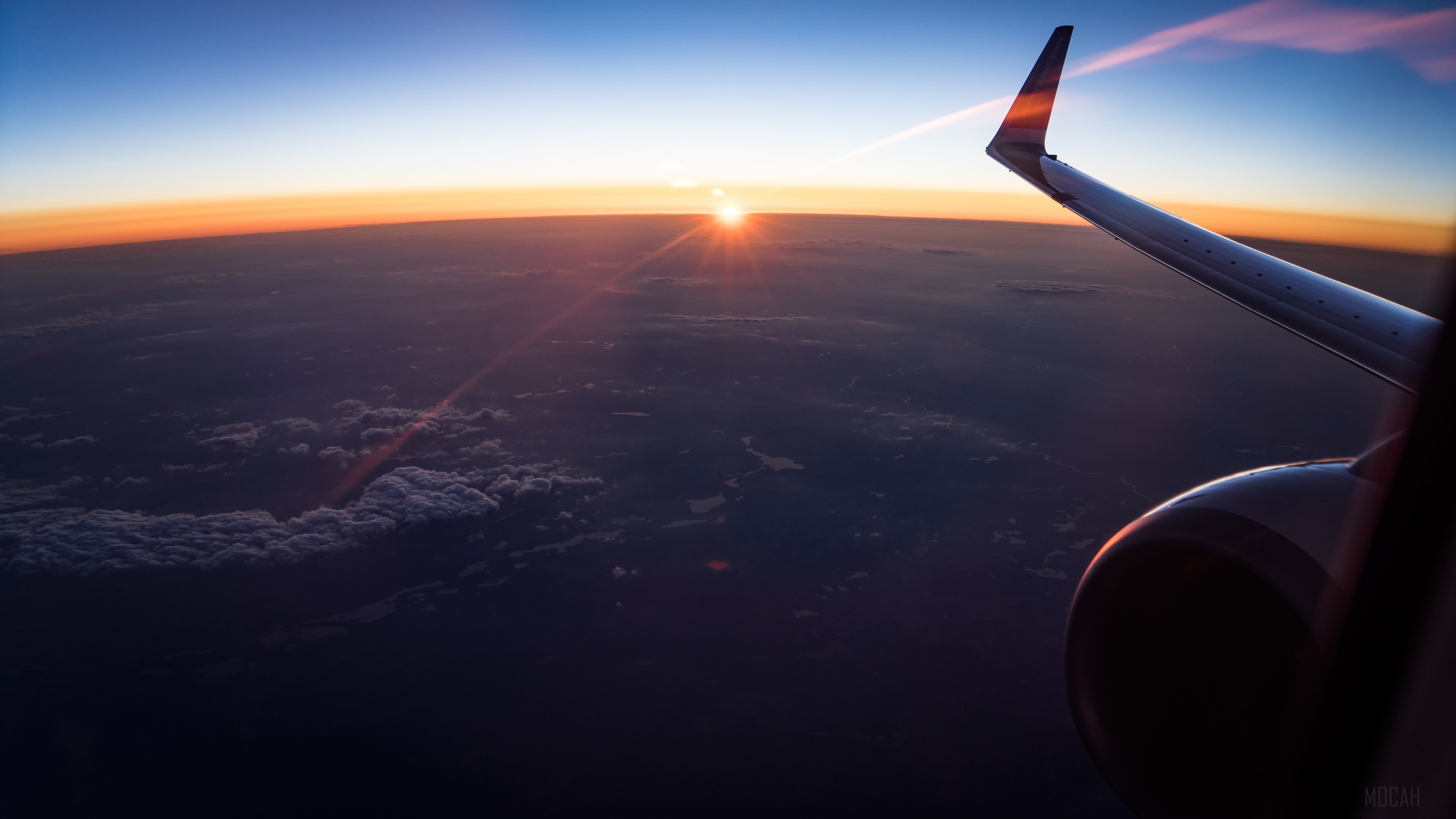 Airplane wing over clouds at sunset 4K HD Wallpaper