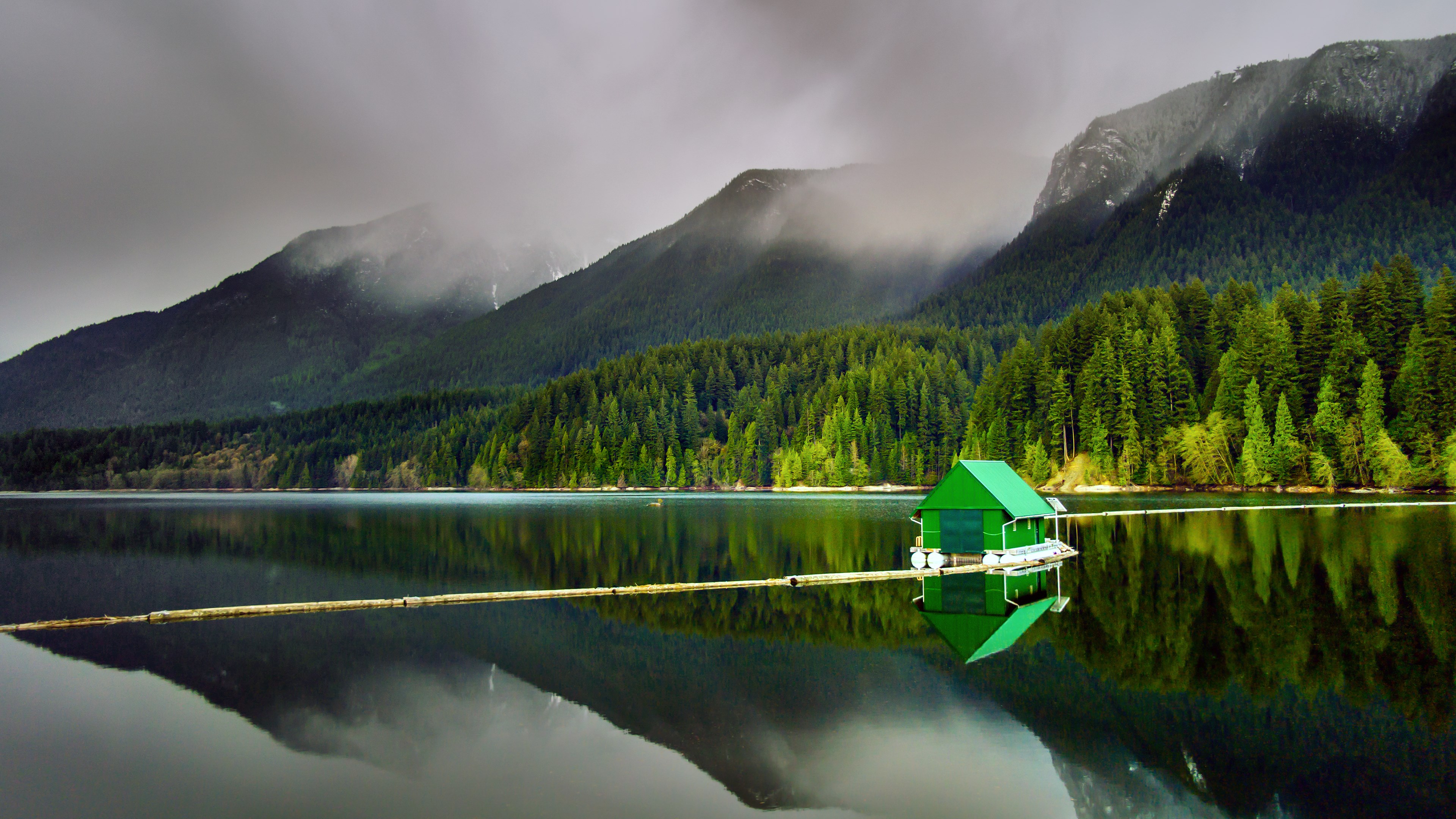 Green boathouse on a lake with mountains HD Wallpaper