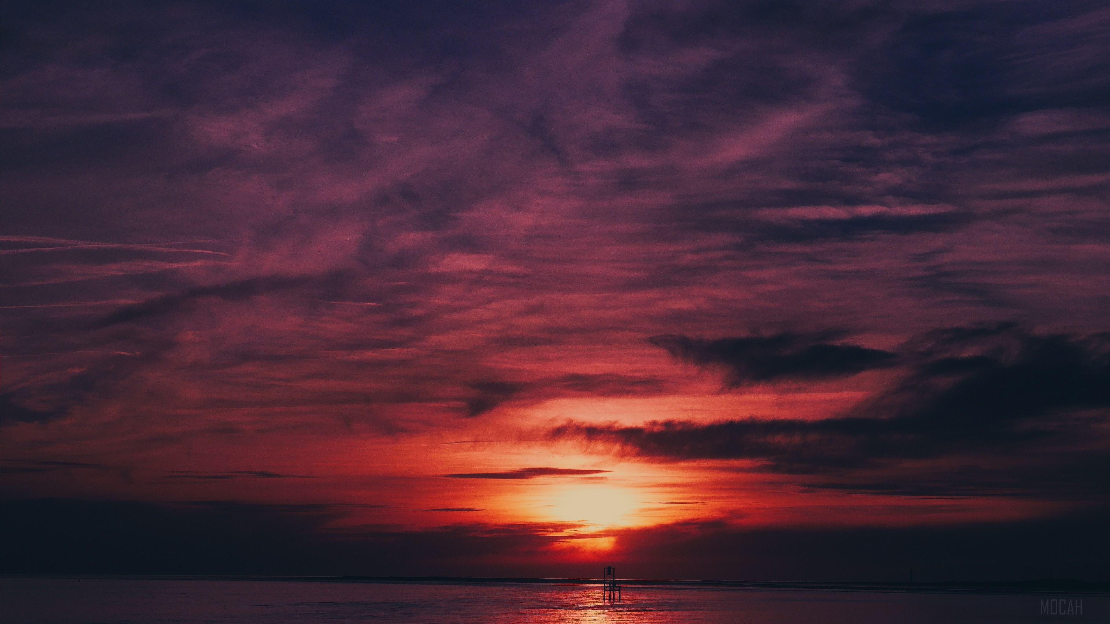 Sunset over the sea with flares and reflection HD Wallpaper