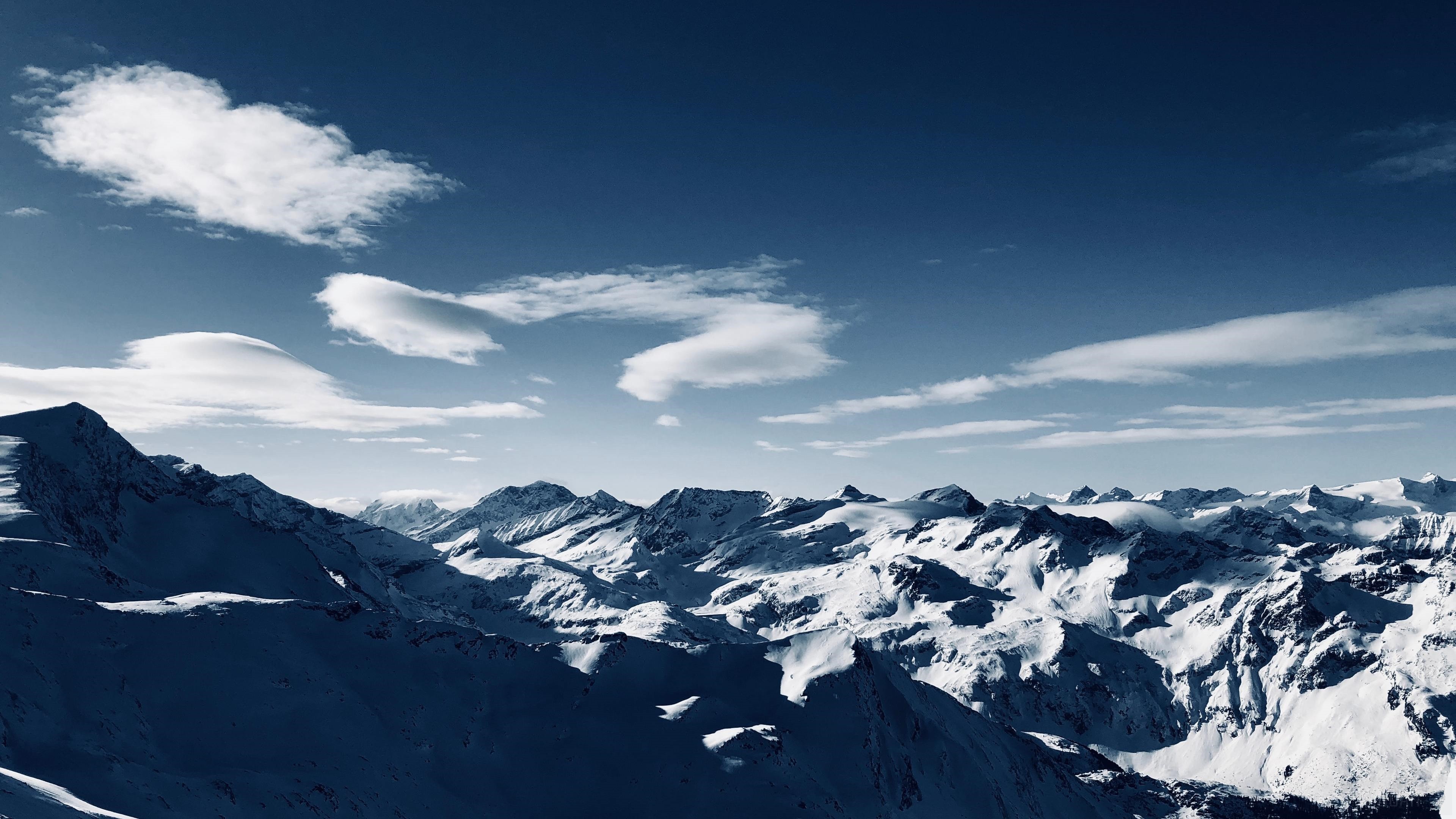 Snowy Mountains Under a Blue Sky HD Wallpaper