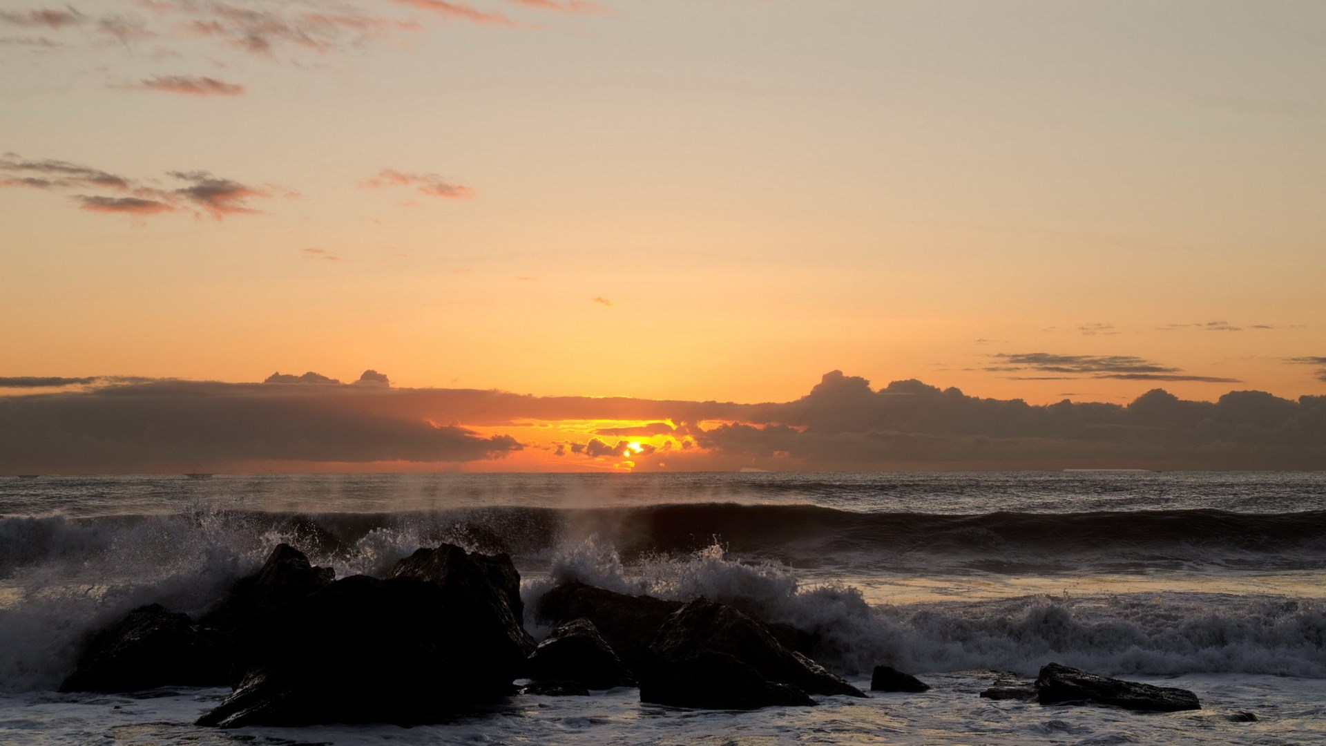 Ocean waves crashing on rocks at sunset HD Wallpaper