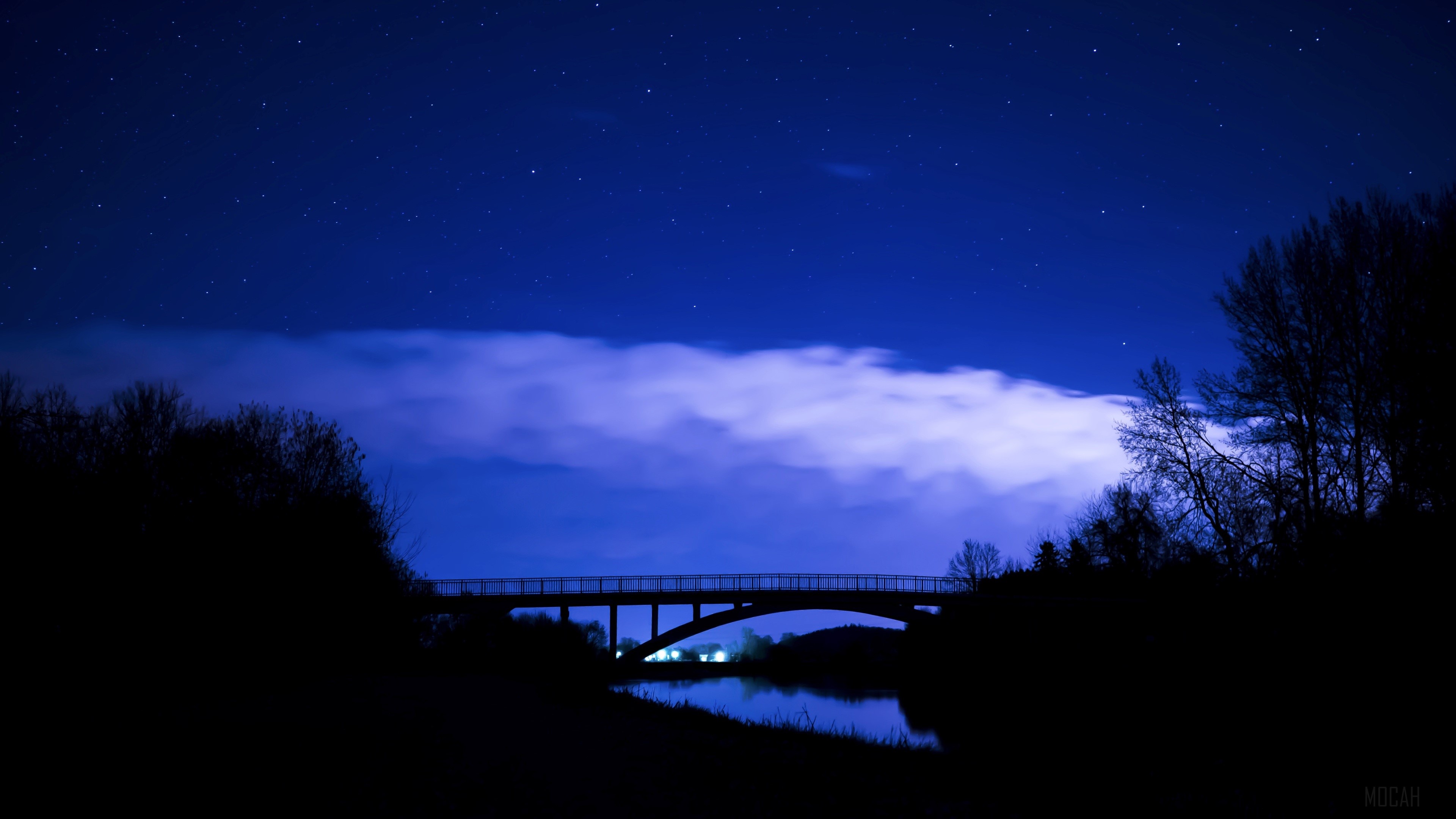 Bridge at Night Under Starry Sky with Clouds 4K HD Wallpaper
