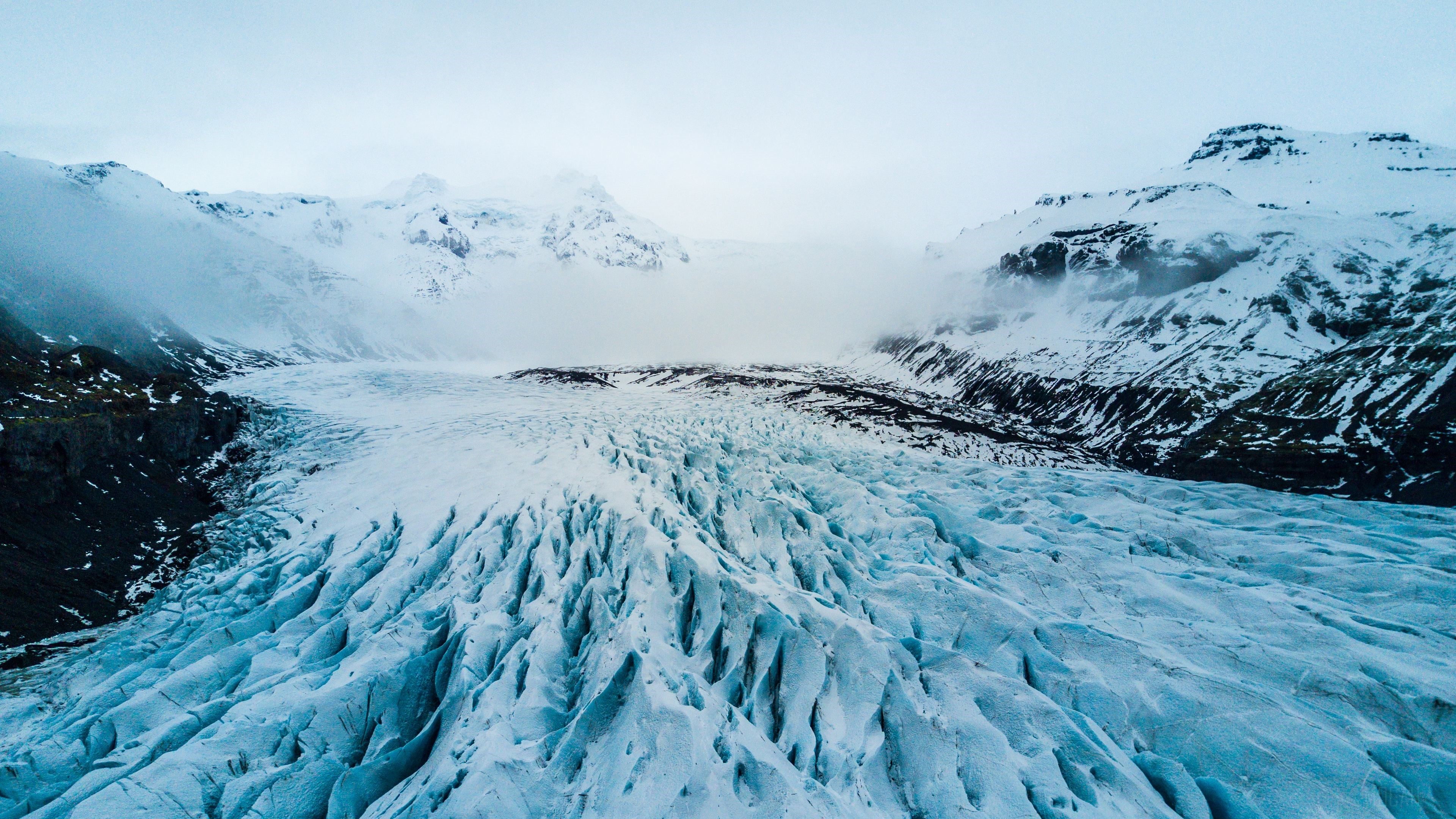 Glacier with snow-capped mountains and fog HD Wallpaper
