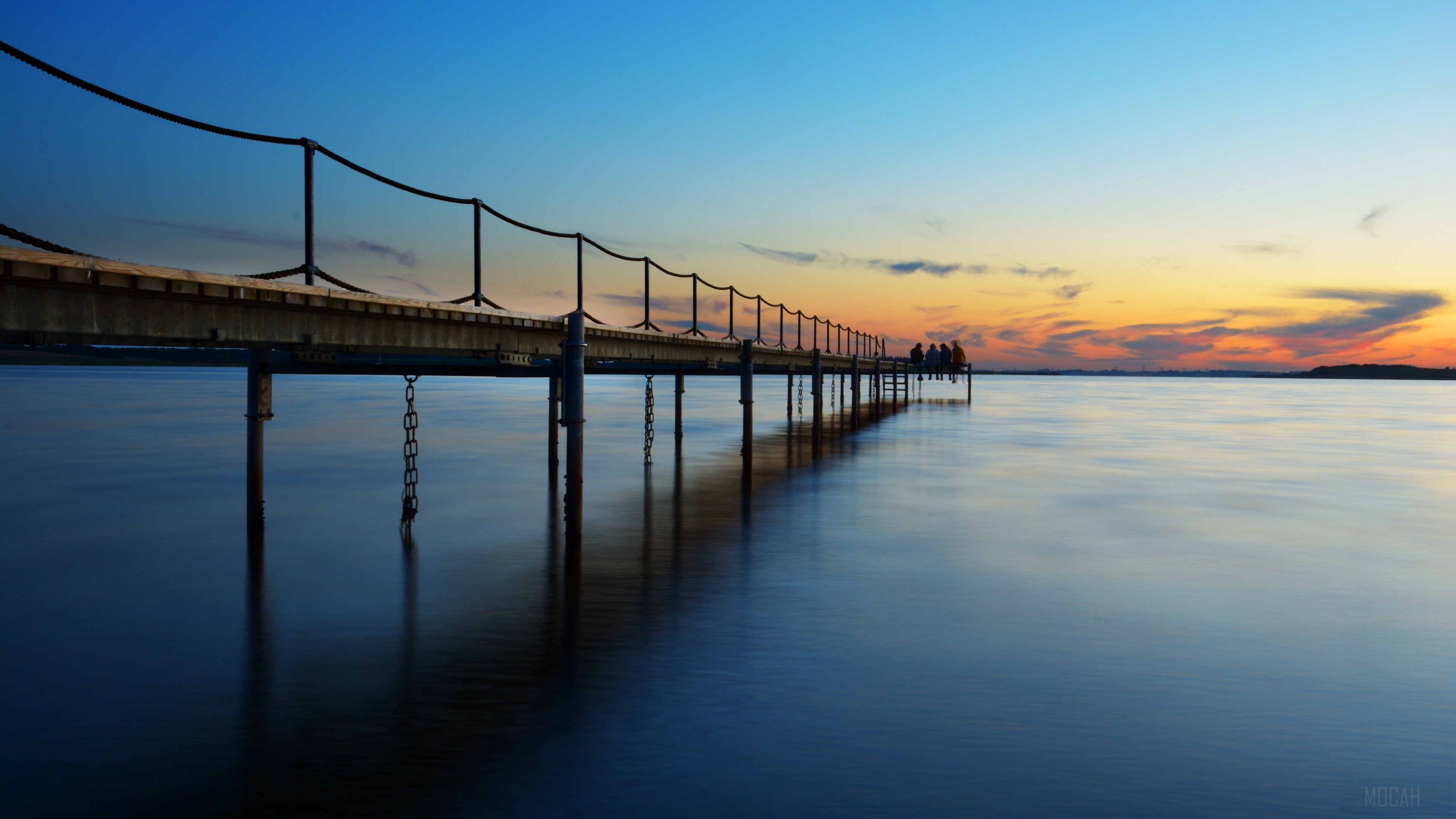 Pier over water at sunset 4K HD Wallpaper