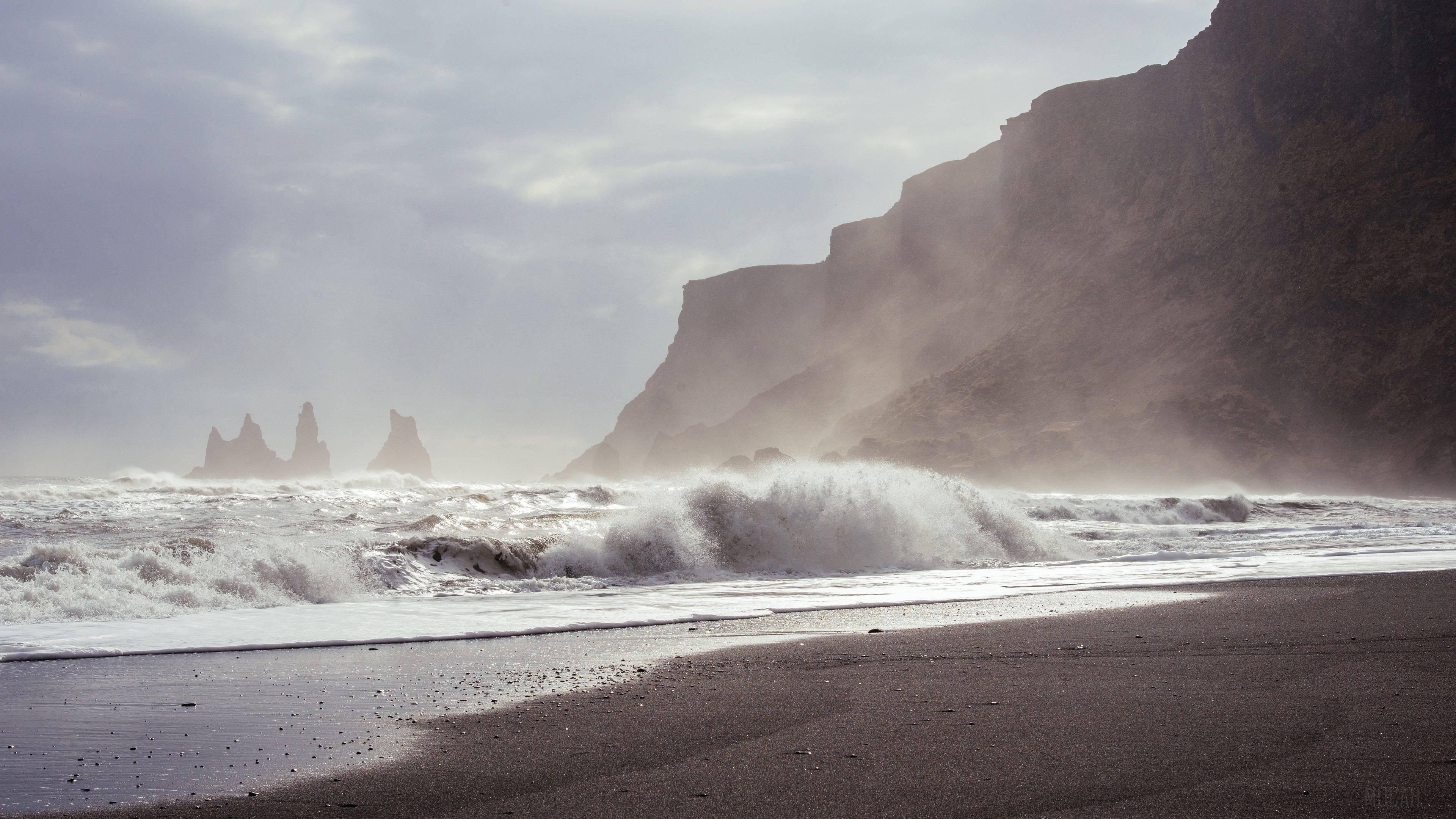 Waves crashing on a black sand beach with sea stacks HD Wallpaper