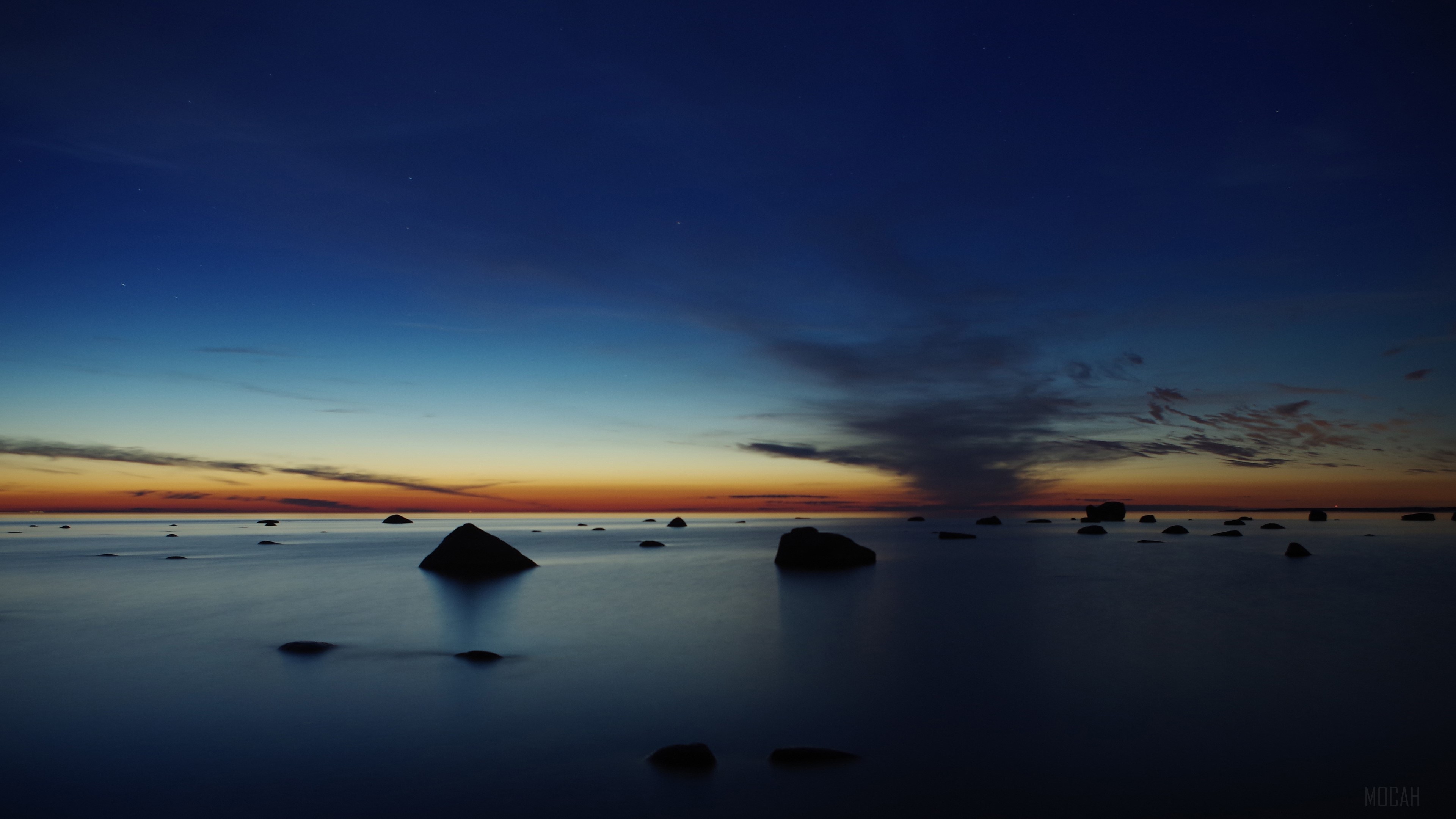 Rocks in the ocean at dusk HD Wallpaper
