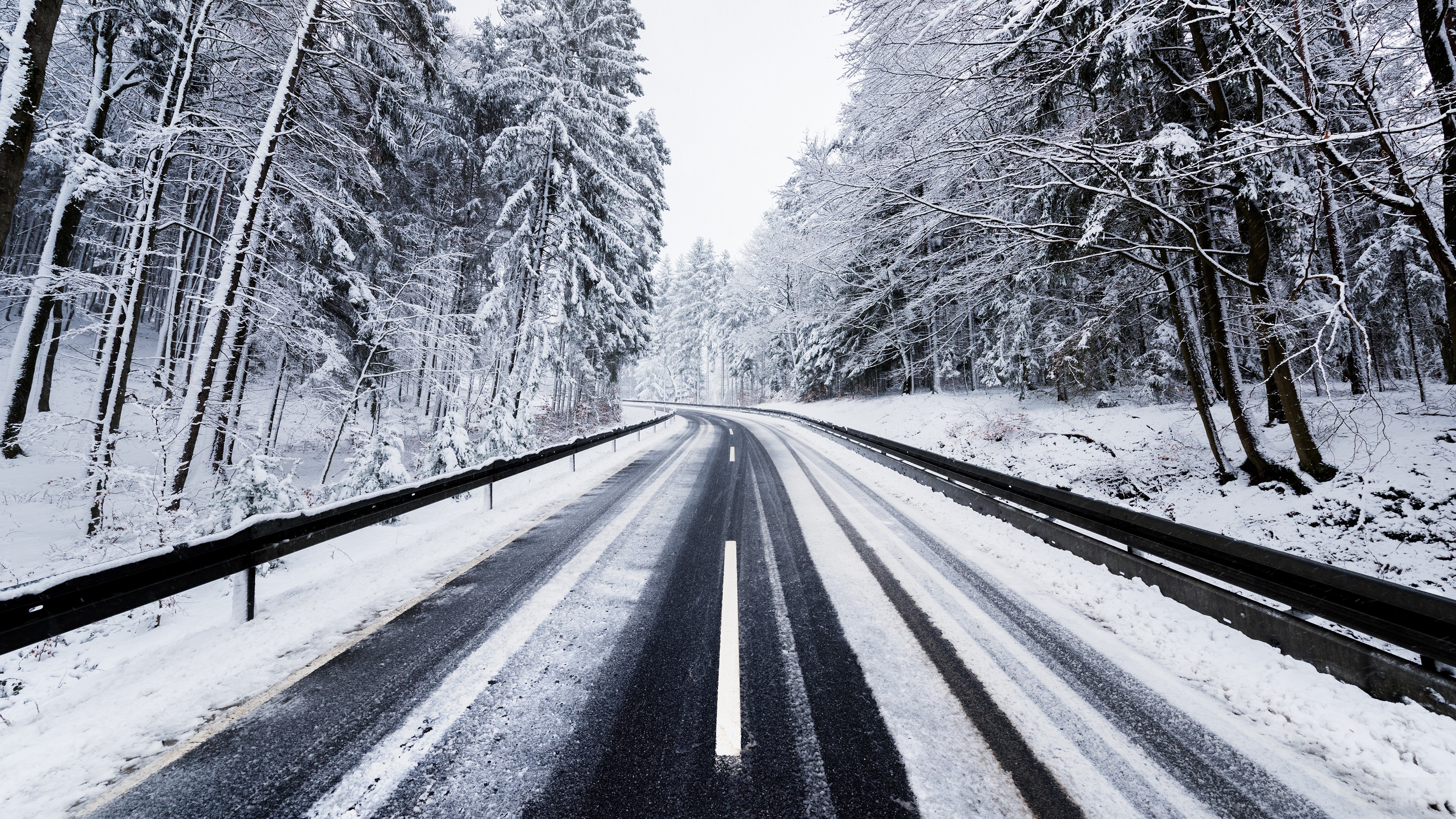 Winter Road Through Snowy Forest 4K HD Wallpaper